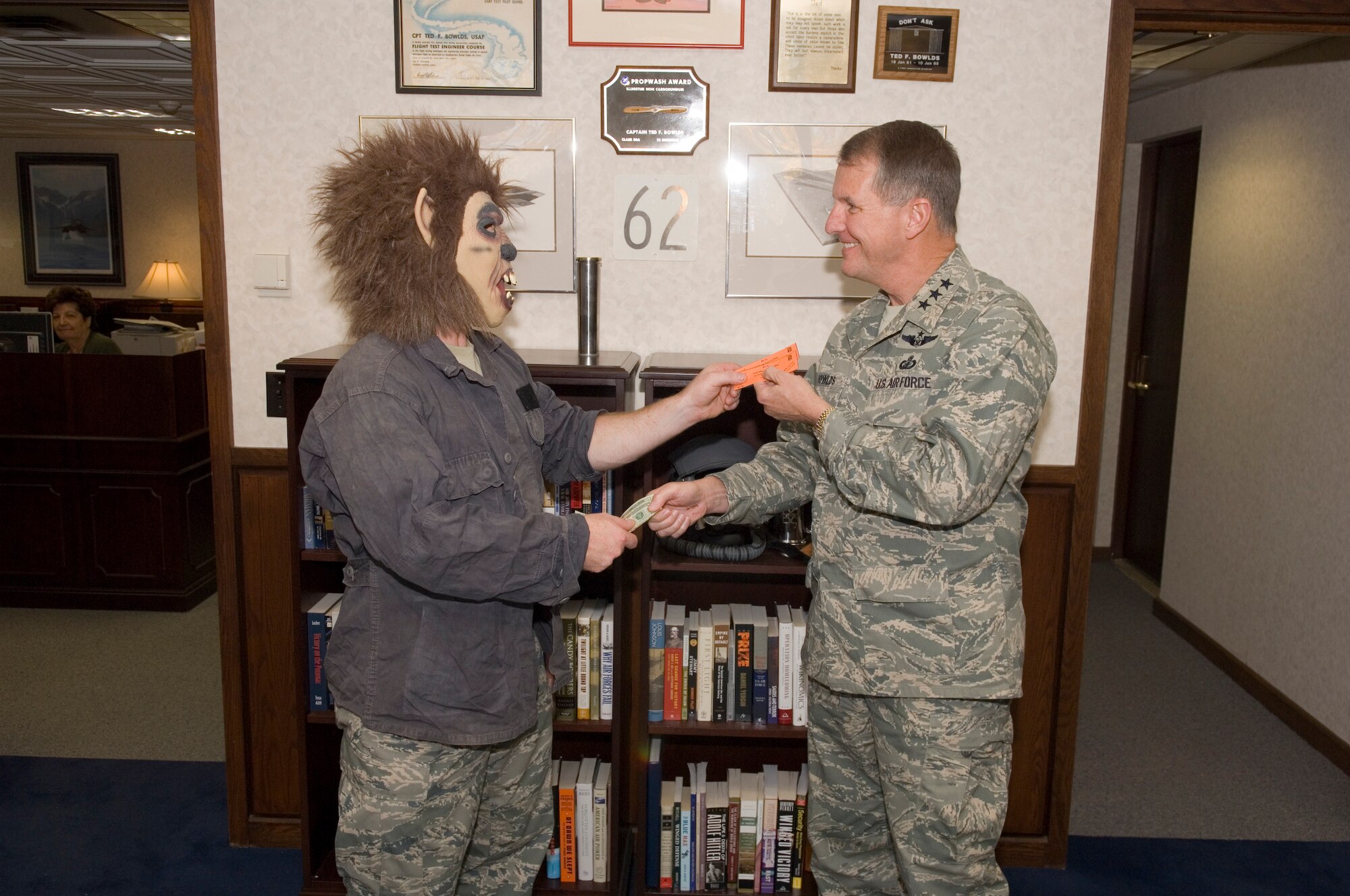 HANSCOM AFB, Mass. - Lt. Gen. Ted Bowlds, Electronic Systems Center commander, purchases tickets for a Halloween Party that will be held at the Minuteman Club, Oct. 24, from 8 p.m. to midnight. The party will feature live music from “The Rock Daddys” and a costume contest; all proceeds go to the Combined Federal Campaign. Tickets are $10 in advance or $12 at the door and can be purchased from unit CFC representatives or by contacting Captain Max Gulezian at (781) 377-6674. (U.S. Air Force photo by Rick Berry)