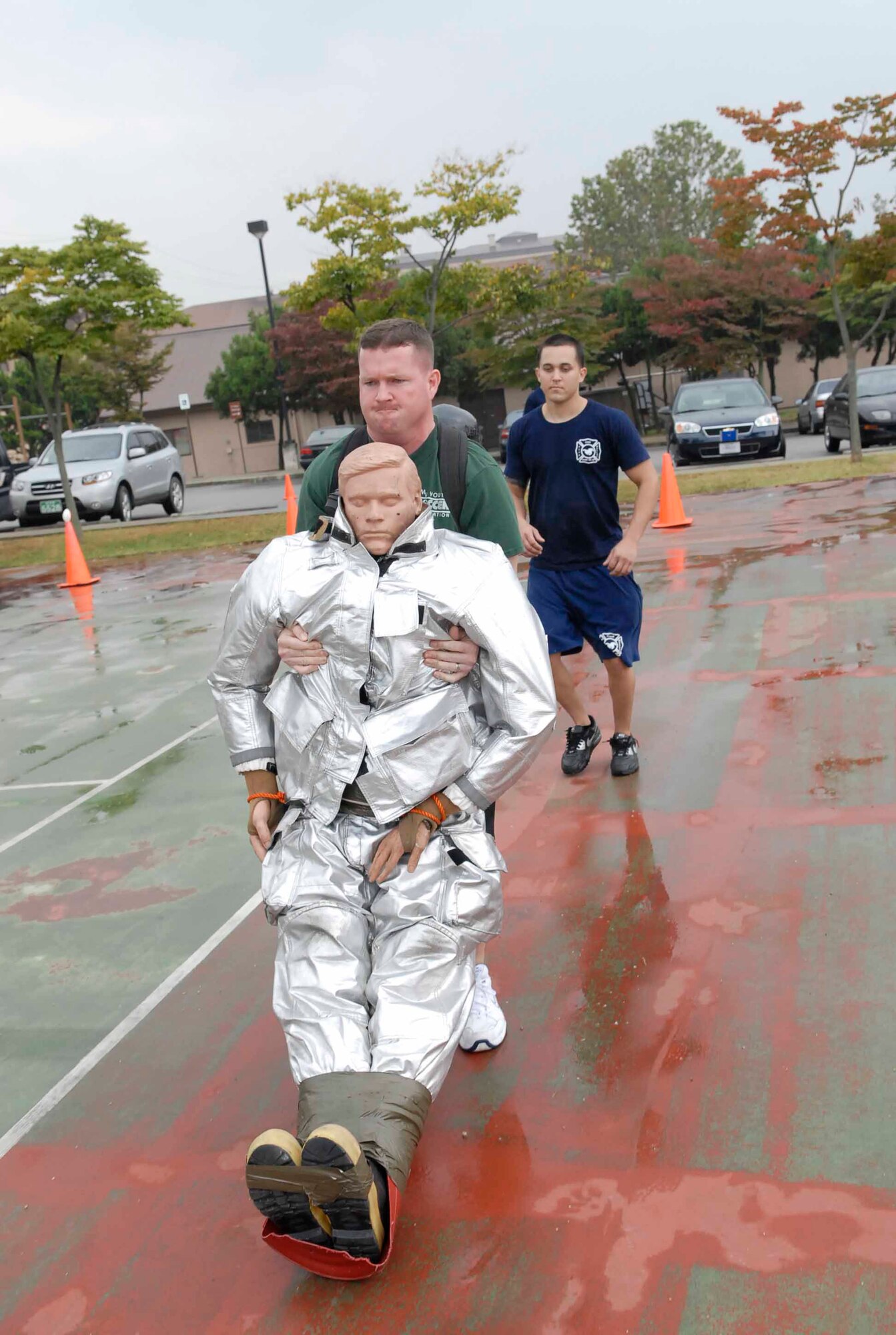 OSAN AIR BASE, Republic of Korea -- Tech. Sgt. Kenneth Allen, 51st Civil Engineer Squadron dormitory manager, drags "Rescue Randy", a 175-pound dummy, during the base's Firefighter Challenge Oct. 10 at the base fitness center. Five four-person teams competed in the challenge which also included a 100-foot weave with airpack, 100-foot stretcher carry, 100-foot hose carry and a 100-foot hose drag. (U.S. Air Force photo/Staff Sgt. Scottie McCord)