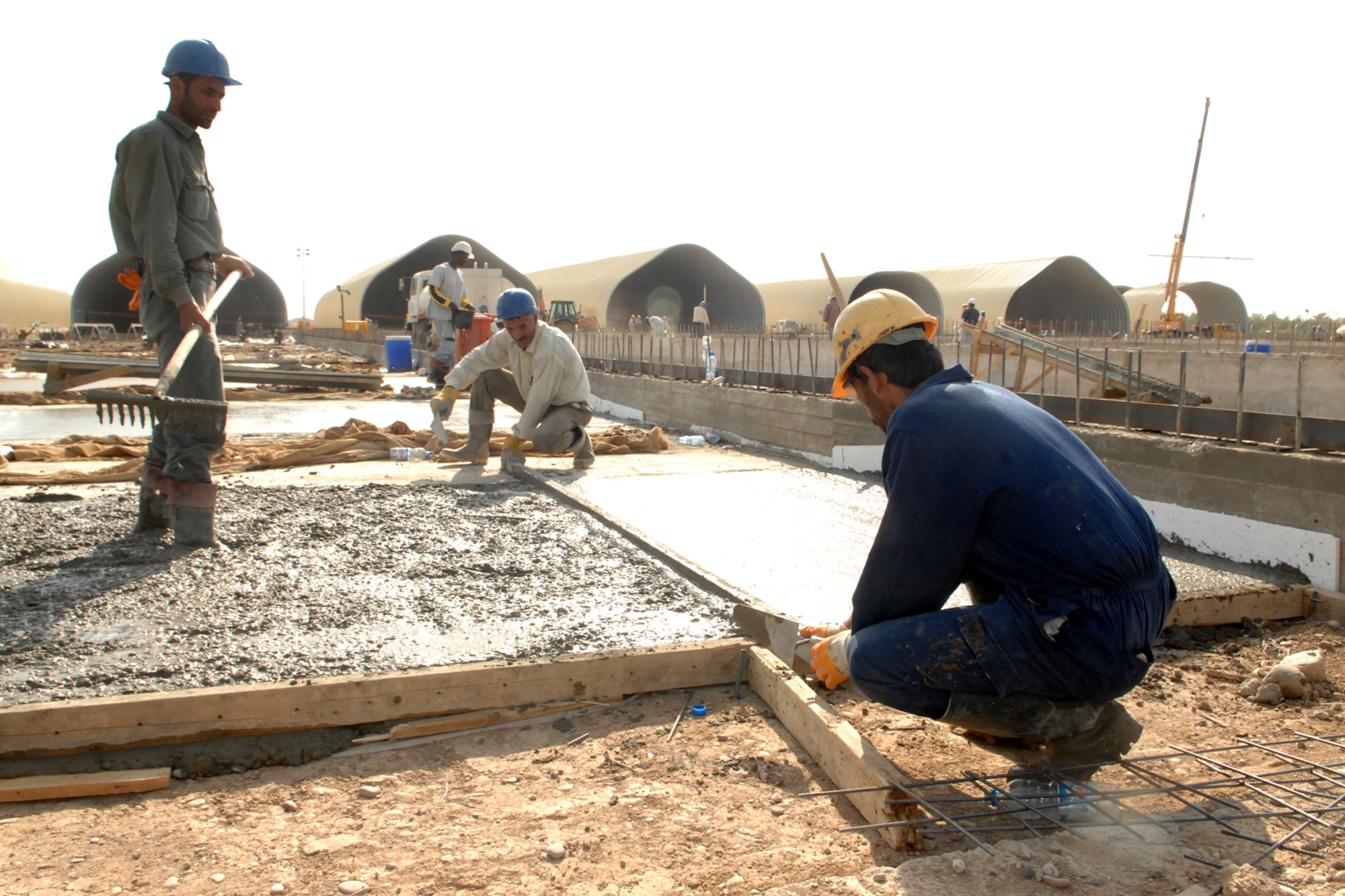 KIRKUK REGIONAL AIR BASE, Iraq ? Workers prepare concrete for the base of a K-Spans building being constructed here.  When completed at the end of the year, the building will be part of a $30 million complex, which will include 24 buildings and support 880 Iraqi air force personnel. (U.S. Air Force photo/Senior Airman Randi Flaugh)