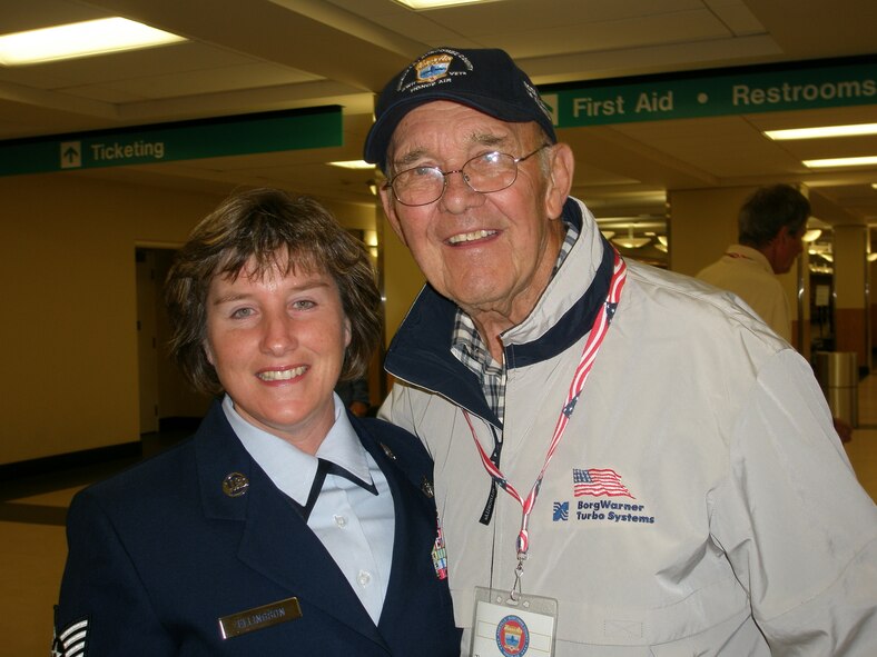 ASHEVILLE, N.C. -- Tech. Sgt. Lois Ellingson, a climatological technical information specialist here with the 14th Weather Squadron, poses with World War II veteran Travis Robinson after returning from their Honor Air flight to Washington D.C. Sept. 27. Sergeant Ellingson served as an Honor Air guardian to Mr. Robinson and two other former Soldiers on the trip. (Courtesy photo)