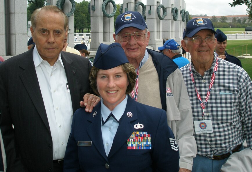Washington D.C. -- Former Kansas Senator and World War II veteran Bob Dole poses for a picture with Tech. Sgt. Lois Ellingson, Phillip Organ Jr. and Travis Robinson during their Honor Air flight to the World War II Memorial Sept. 27. Sergeant Ellingson served as an Honor Air guardian for Mr. Organ and Mr. Robinson who were Soldiers during World War II. (Courtesy photo)