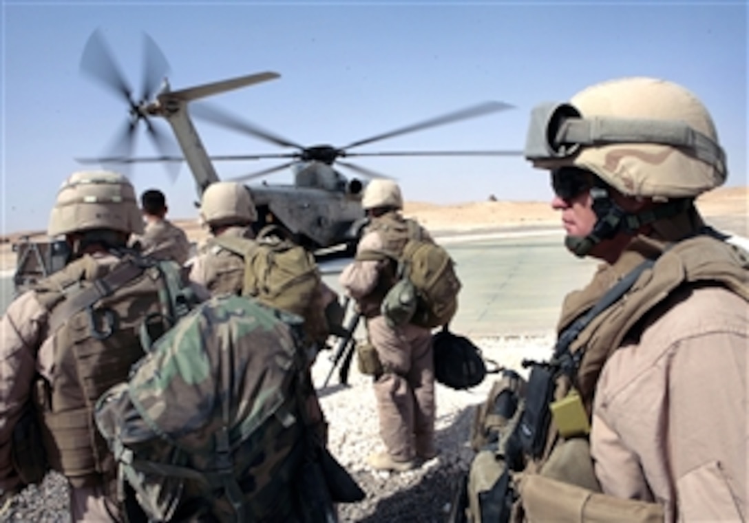 U.S. Navy Command Master Chief James Heiland prepares to board a Marine CH-53 helicopter during a visit to a Naval Mobile Construction Battalion 27 worksite in western Iraq, Oct. 6, 2008. Heiland is a Seabee assigned to the battalion. These Seabees, also known as the 'Skibees," have been constructing a medical facility and huts in Iraq.