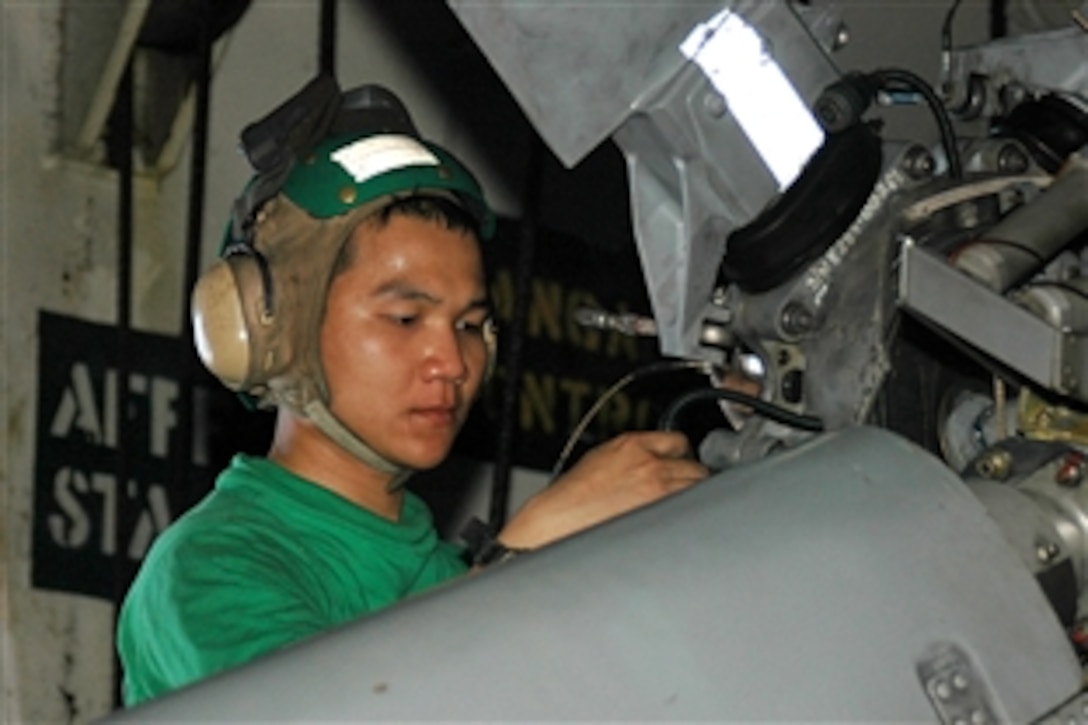 U.S. Navy Seaman Khanhduy Ngo installs a tail rotor blade on an SH-60B Sea Hawk helicopter in the hangar bay of the aircraft carrier USS George Washington, Oct. 13, 2008. Ngo is an aviation machinist's mate assigned to Helicopter Anti-Submarine Squadron Light 51. The George Washington Carrier Strike Group is training in the Pacific Ocean.