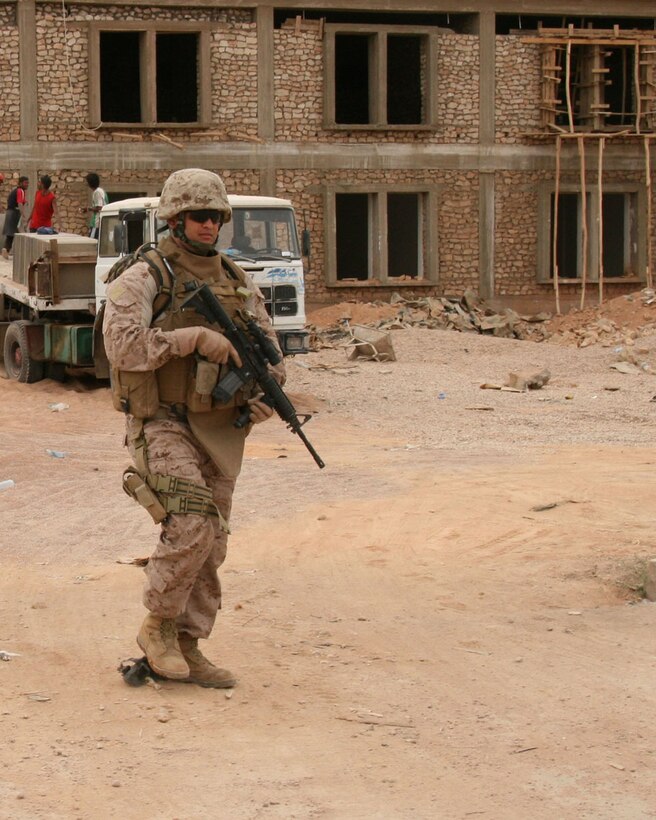 Sgt. Joan A. Ferreira, a 24-year-old team leader with Task Force Military Police, Multi-National Force-West, leads his Marines on patrol through a construction site near the Port of Trebil on Oct. 15, 2008.  Ferreira is a New York City police officer and Individual Ready Reservist currently on one-year mobilization orders.