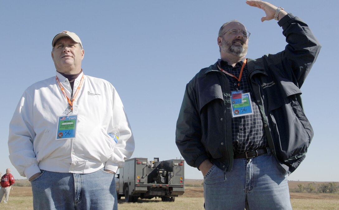 Aaron Powell, right, reminisces of his days as a Marine when he called for air-support and was surprised to see an A-10 come from the sky. Larry Powell, fellow Salina City Council member intently listenned as Warthogs roamed the sky. Salina's Smoky Hill Range hosted the Hawgsmoke 2008 bombing and gunnery competition as distinguished guests and members of the press looked on in awe.  (U.S. Air Force photo/Staff Sgt. Kent Kagarise)