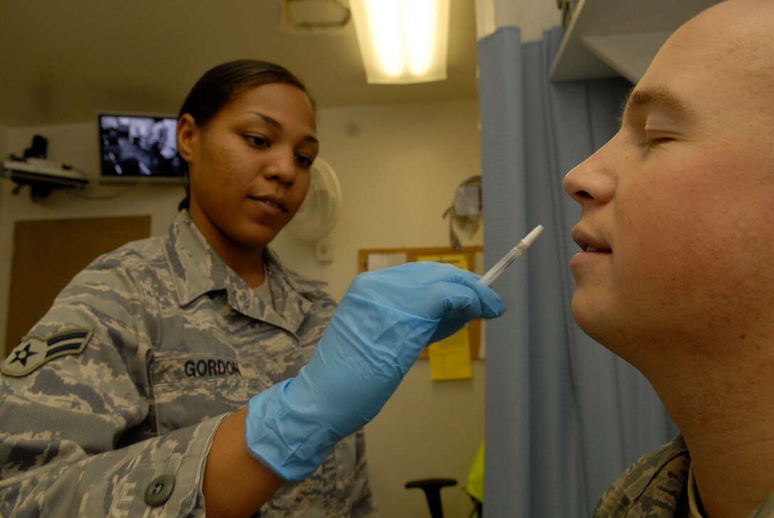 VANDENBERG AIR FORCE BASE, Calif. --  Airman 1st Class Naomi Gordon of the 30th Medical Operations Squadron administers a flu vaccination to Airman 1st Class Chad Usher of the 30th Space Wing here, Oct. 10. (U.S. Air Force photo / Senior Airman Christopher Hubenthal)