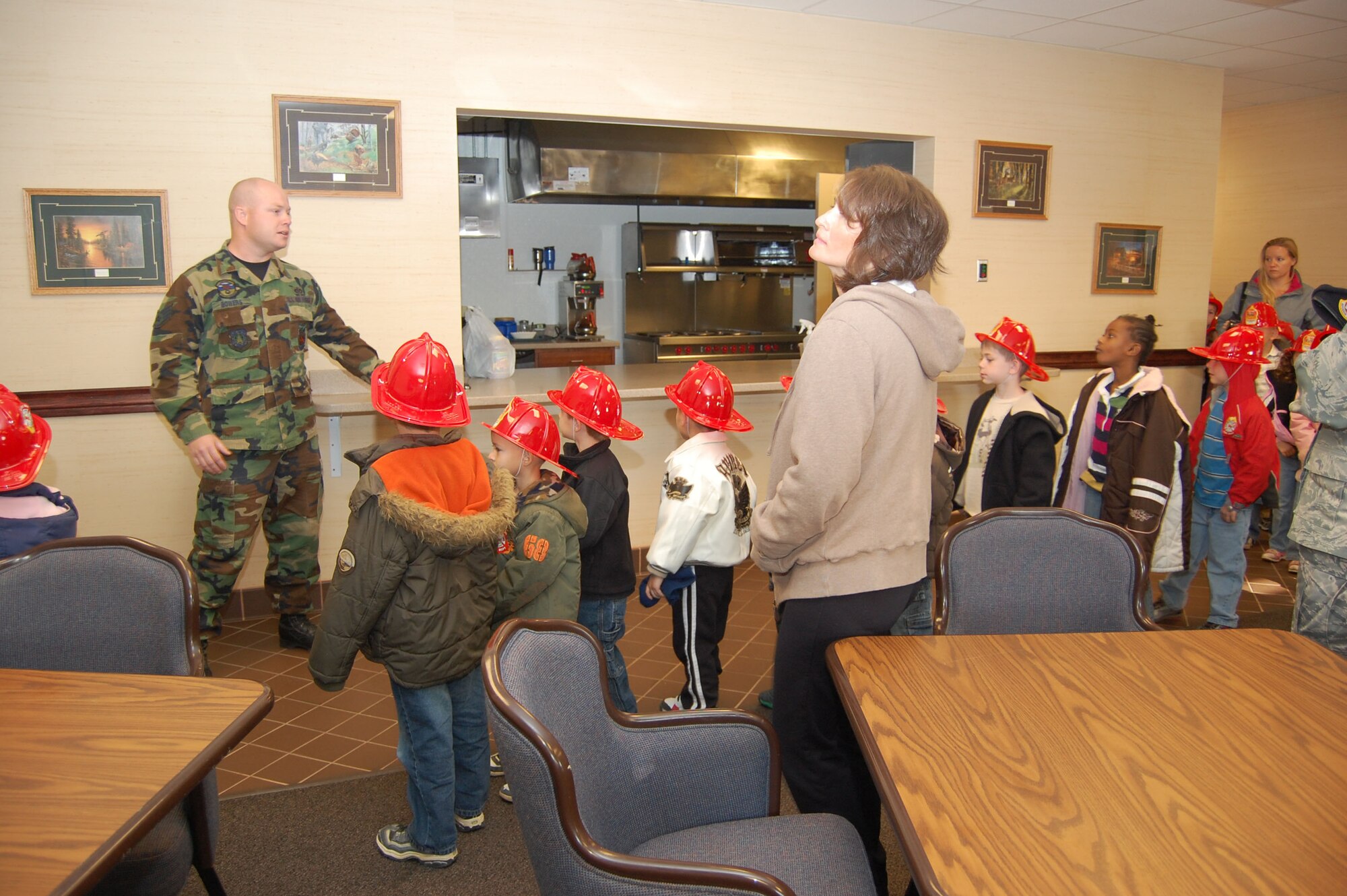 Staff Sgt. Cory Bowers, 341st Civil Engineer Squadron fire crew chief, shows a group of kindergartners from Loy Elementary the kitchen area of Malmstrom's Fire Department. The elementary school students toured the Fire Department during Fire Prevention Week Oct 5 to 11. (U.S. Air Force photo/Senior Airman Emerald Ralston)