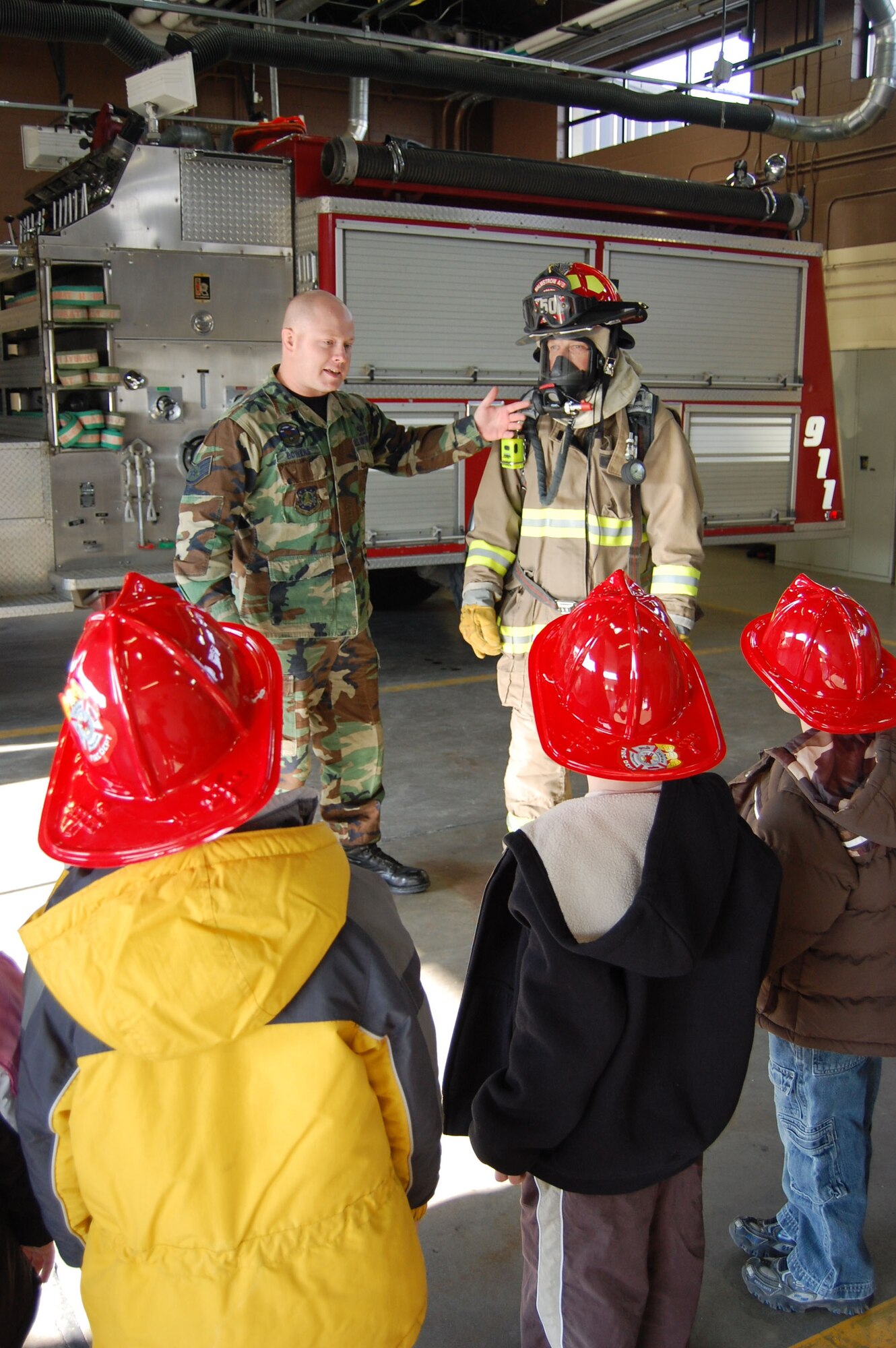 Staff Sgt. Cory Bowers,341st Civil Engineer Squadron fire crew chief, explains the protective gear worn by a firefighter to a group of kindergartners from Loy Elementary during a tour for Fire Prevention Week. Fire Prevention Week was Oct. 5 to 11. (U.S. Air Force photo/Senior Airman Emerald Ralston) 