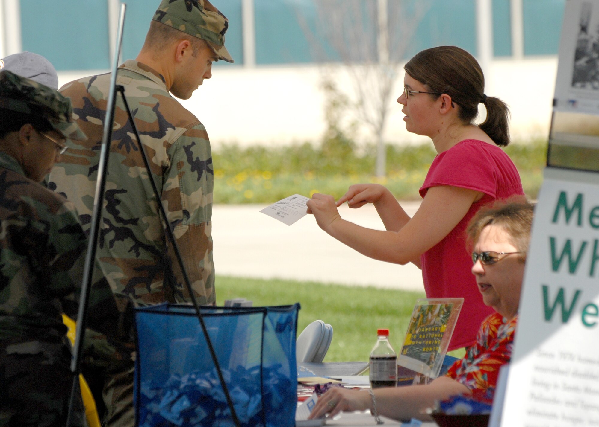 A Los Angeles Air Force Base military member receives information at one of the many Combined Federal Campaign organization booths during the 2008 CFC kickoff in the Schriever Space Complex courtyard, Oct 15. Charitable organizations such as the American Heart Association, American Cancer Association, USO, Big Brothers/Big Sisters, Salvation Army, AIDS ReSearch Alliance, Meals on Wheels West, City of Hope, Mission to Children, the United Way, and others passed out information to attendees.  (Photo by Stephen Schester)