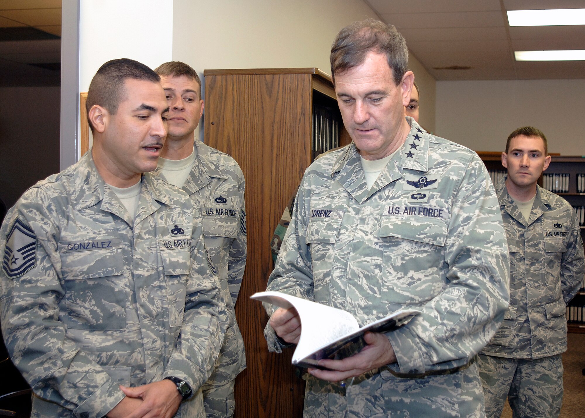 FAIRCHILD AIR FORCE BASE, Wash. – Gen. Stephen Lorenz, Air Education Training Command commander receives field training history book from Senior Master Sgt. Gary Gonzalez, 373rd Training Squadron Detachment 13 on Oct 15. (U.S. Air Force photo / Staff Sgt. JT May III)