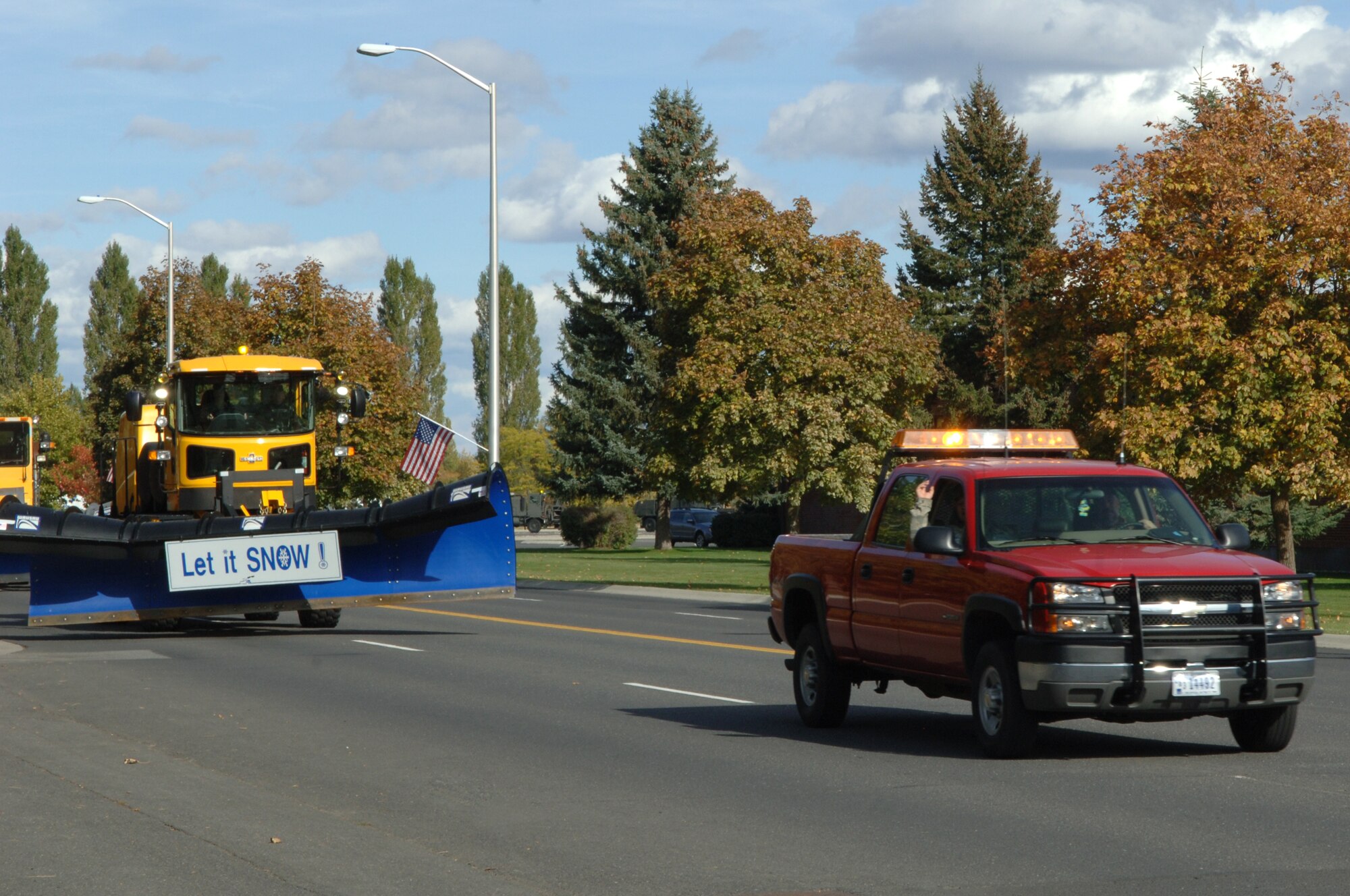 FAIRCHILD AIR FORCE BASE, Wash. – The "Snowman," or airfield snow removal supervisor, leads the Snow Parade, followed by a 20-foot wide airfield snow plow, down Bong Street Oct. 14. The parade demonstrates to the base populace that the 92nd Civil Engineers are ready for the start of the snow removal season. (U.S. Air Force photo / Senior Airman Jocelyn A. Ford)