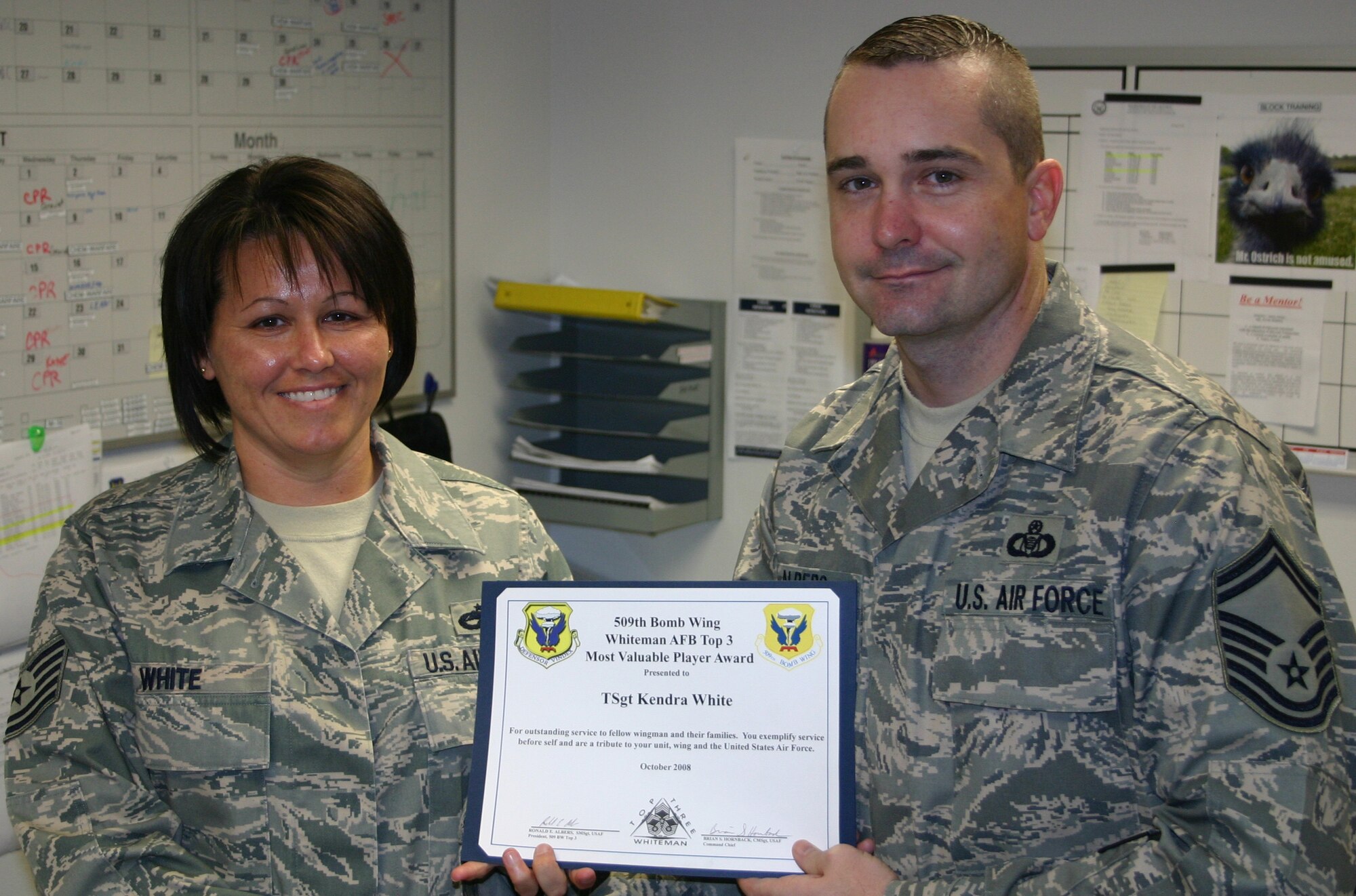 WHITEMAN AIR FORCE BASE, Mo. - Senior Master Sgt. Ron Albers, Whiteman TOP 3, presents the TOP 3 Most Valuable Player award to Tech. Sgt. Kendra White, 509th Munitions Squadron. Sergeant White was the non-commissioned officer in charge of squadron training during the 2008 LSET evaluation. She scrutinized more than 1000 documents for accuracy and validity. In addition, she completed a 100% review of course codes and lesson plans and helped her squadron’s 100% integration into training business administration. The Top 3 MVP award is given each month to any technical sergeant or below throughout the wing. This is the Top 3's way to formally recognize an enlisted individual who epitomizes mission accomplishment, teamwork and esprit de corps for the men and women of the 509th Bomb Wing. (Photo printed with permission of Master Sgt. Bartley Fischer)