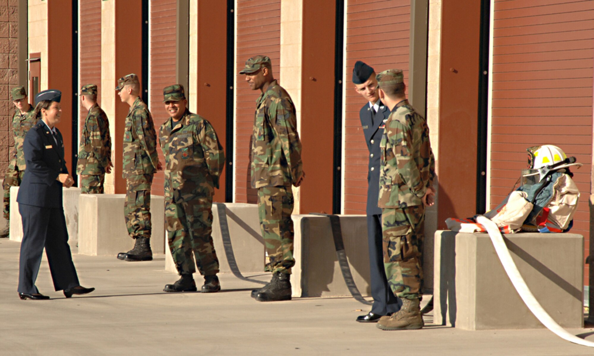 Chaplain Captain Olga Westfall, 49th Fighter Wing Chapel, meets with Airmen outside the new Fire Station 1 at Holloman Air Force Base, N.M., October 9. The new fire station is the first for Holloman in over 52 years. (U.S. Air Force photo/ Senior Airman Tiffany Trojca)