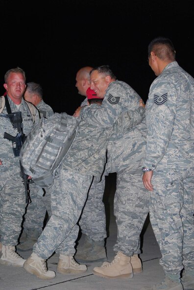 About 110 Airmen from the 556th REDHORSE Squadron returned from deployment on Sunday, October 12, 2008. When the Reserve Airmen arrived home, about 300 friends, family and unit members were there to welcome them with hugs and hand-made banners. REDHORSE is an acronym for Rapid Engineer Deployable Heavy Operational Repair Squadron Engineers. The REDHORSE Airmen deployed to three different countries within the U.S. Central Command Area of Responsibility. During the deployment, they dug wells for Afghanis, repaired existing structures in Iraq and supported base construction and repair needs throughout the AOR. The 556th REDHORSE Squadron is due to relocate to Florida later this year but many of the Reservists will remain at Lackland Air Force Base as new members of the 433rd Civil Engineer Squadron. (U.S. Air Force Photo/Master Sgt. Collen McGee) 