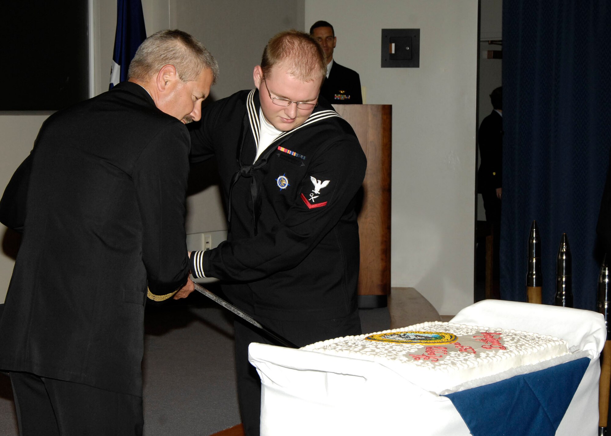 U.S. Navy Commander, Michael Duprey, and Intelligence Specialist Petty Officer Third Class, Robert McGhee, U.S. Transportation Command, cut the birthday cake during the U.S. Navy's 233rd birthday ceremony Tuesday.

(U.S. Air Force photo/Senior Airman Jonathan Lovelady)
