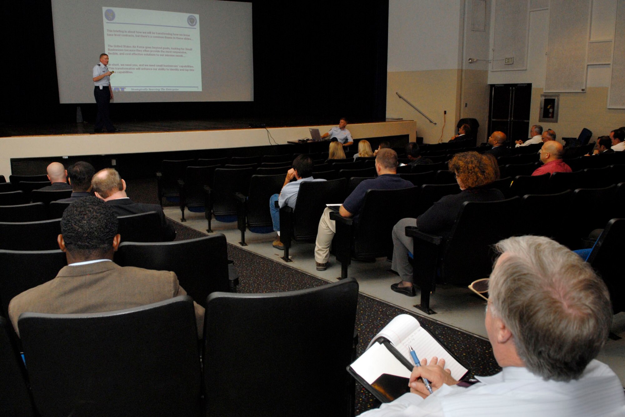 Col. Steve Elliot, 788th Installation Acquisition Group provisional director, discusses some of the changes the Installation Acquisition Transformation program will bring to the Air Force in terms of contracts and local small businesses during the town hall meeting at the Base Theater Oct. 6. The IAT is an Air Force-wide initiative to modify contracting business practices at the continental U.S. installation level to create more efficient acquisition processes.