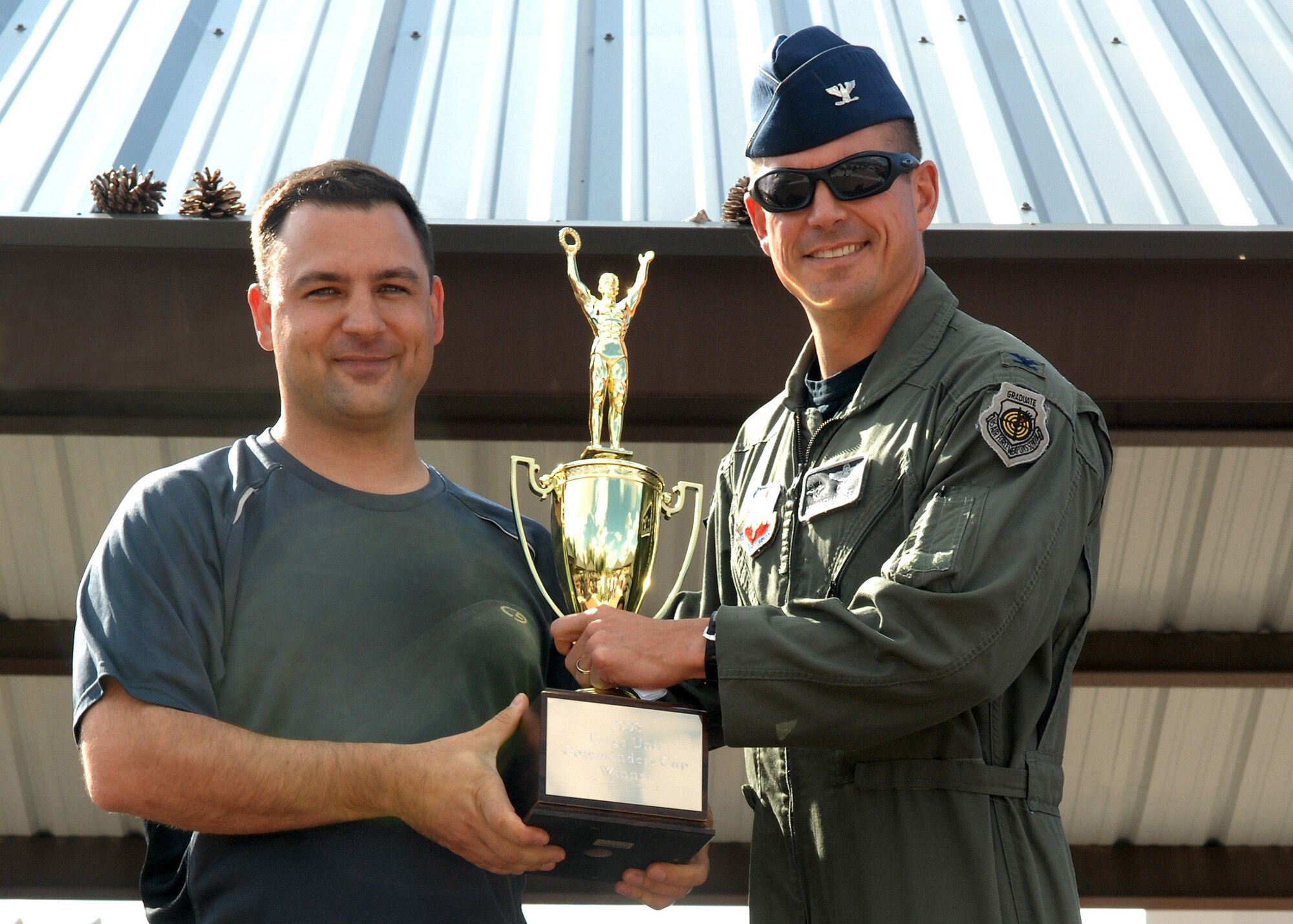 Maj. Nathan Clemmer, 49th Civil Engineer Squadron commander, is awarded the large squadron Commander's Cup for the entire year award from Col. Michael McGee, 49th Fighter Wing vice commander at Holloman Air Force Base, N.M., October 10. Awards were presented to winning squadrons who participated during Sports Day. (U.S. Air Force photo/Airman 1st Class Veronica Salgado)
