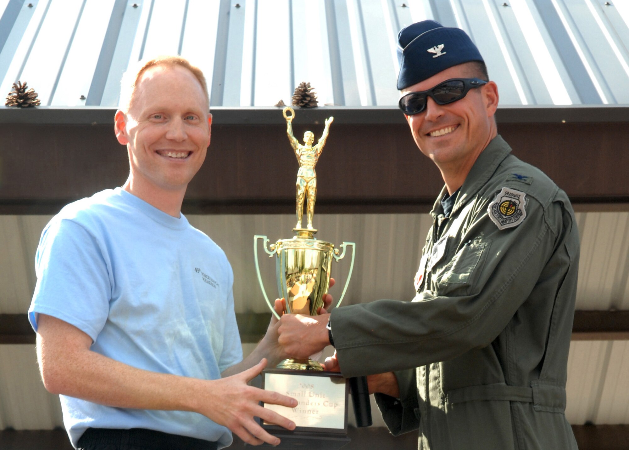 Maj. Kurt Menke, 49th Force Support Squadron commander, receives small squadron Commander's Cup for the entire year award from Col. Michael McGee, 49th Fighter Wing vice commander, at Holloman Air Force Base, N.M., October 10. Awards were presented to winning squadrons who participated during Sports Day. (U.S. Air Force photo/Airman 1st Class Veronica Salgado)