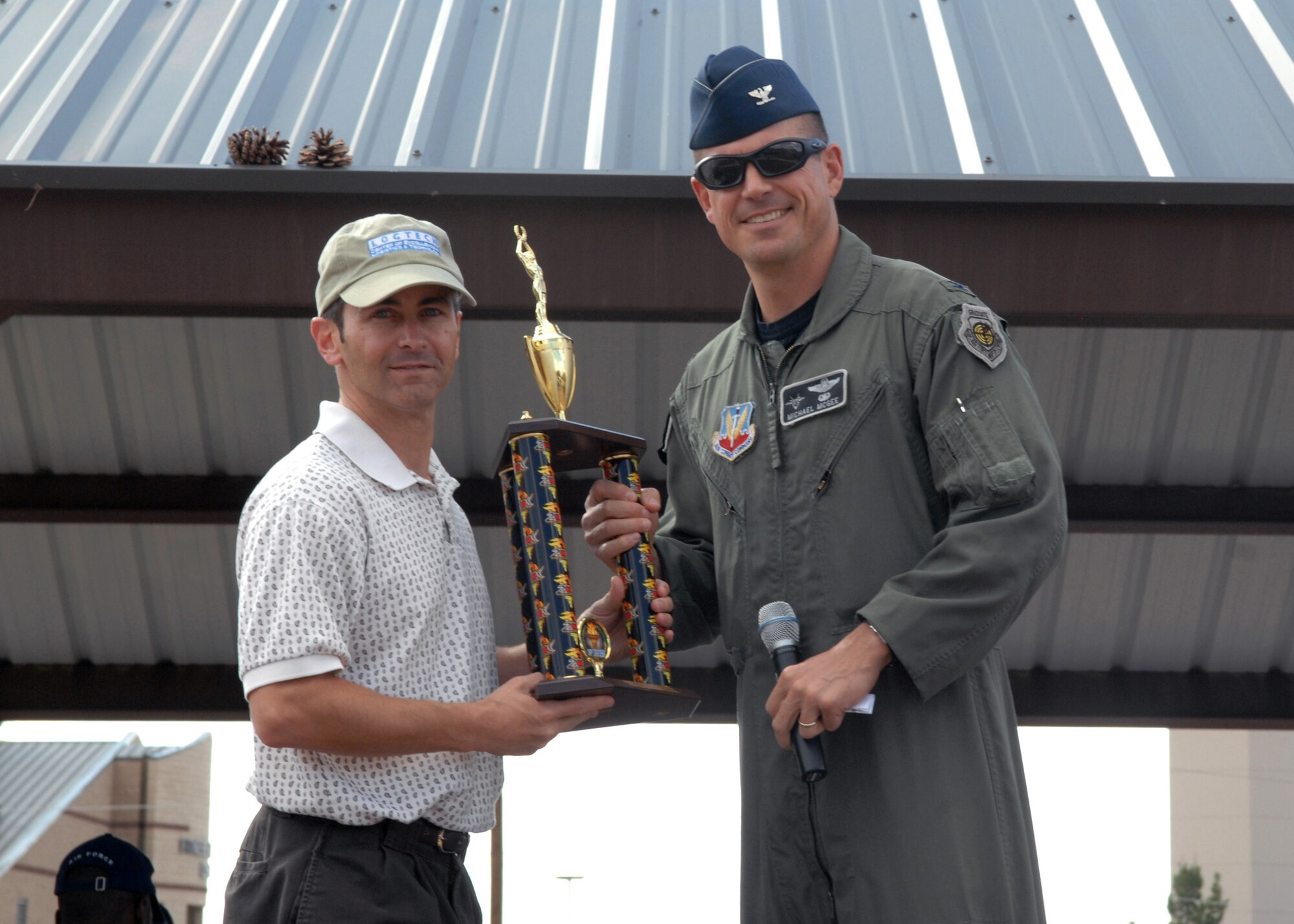 Lt. Col. Steve James, 49th Aircraft Maintenance Squadron commander, receives first place (Small Squadron award) by Col. Michael McGee, 49th Fighter Wing vice commander, at Holloman Air Force Base, N.M., October 10. Awards were presented to winning squadrons who participated during Sports Day. (U.S. Air Force photo/Airman 1st Class Veronica Salgado)