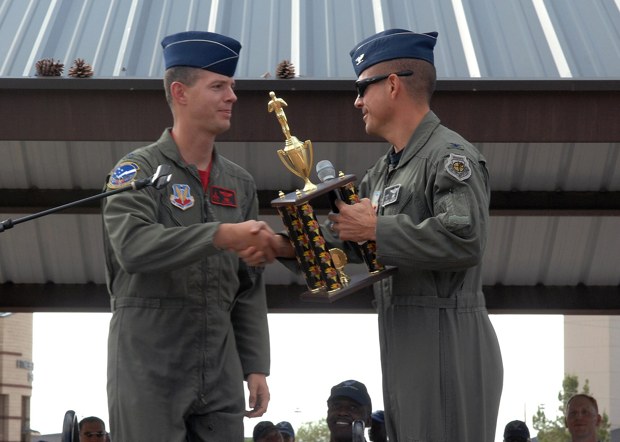 Lt. Col. Alexus Grynkewich, 49th Operations Support Squadron commander, receives second place (Small Squadron award) from Col. Michael McGee, 49th Fighter Wing vice commander, at Holloman Air Force Base, N.M., October 10. Awards were presented to winning squadrons who participated during Sports Day. (U.S. Air Force photo/Airman 1st Class Veronica Salgado)