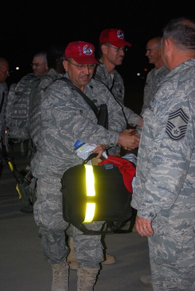 About 110 Airmen from the 556th REDHORSE Squadron returned from deployment on Sunday, October 12, 2008. When the Reserve Airmen arrived home, about 300 friends, family and unit members were there to welcome them with hugs and hand-made banners. REDHORSE is an acronym for Rapid Engineer Deployable Heavy Operational Repair Squadron Engineers. The REDHORSE Airmen deployed to three different countries within the U.S. Central Command Area of Responsibility. During the deployment, they dug wells for Afghanis, repaired existing structures in Iraq and supported base construction and repair needs throughout the AOR. The 556th REDHORSE Squadron is due to relocate to Florida later this year but many of the Reservists will remain at Lackland Air Force Base as new members of the 433rd Civil Engineer Squadron. (U.S. Air Force Photo/Master Sgt. Collen McGee) 