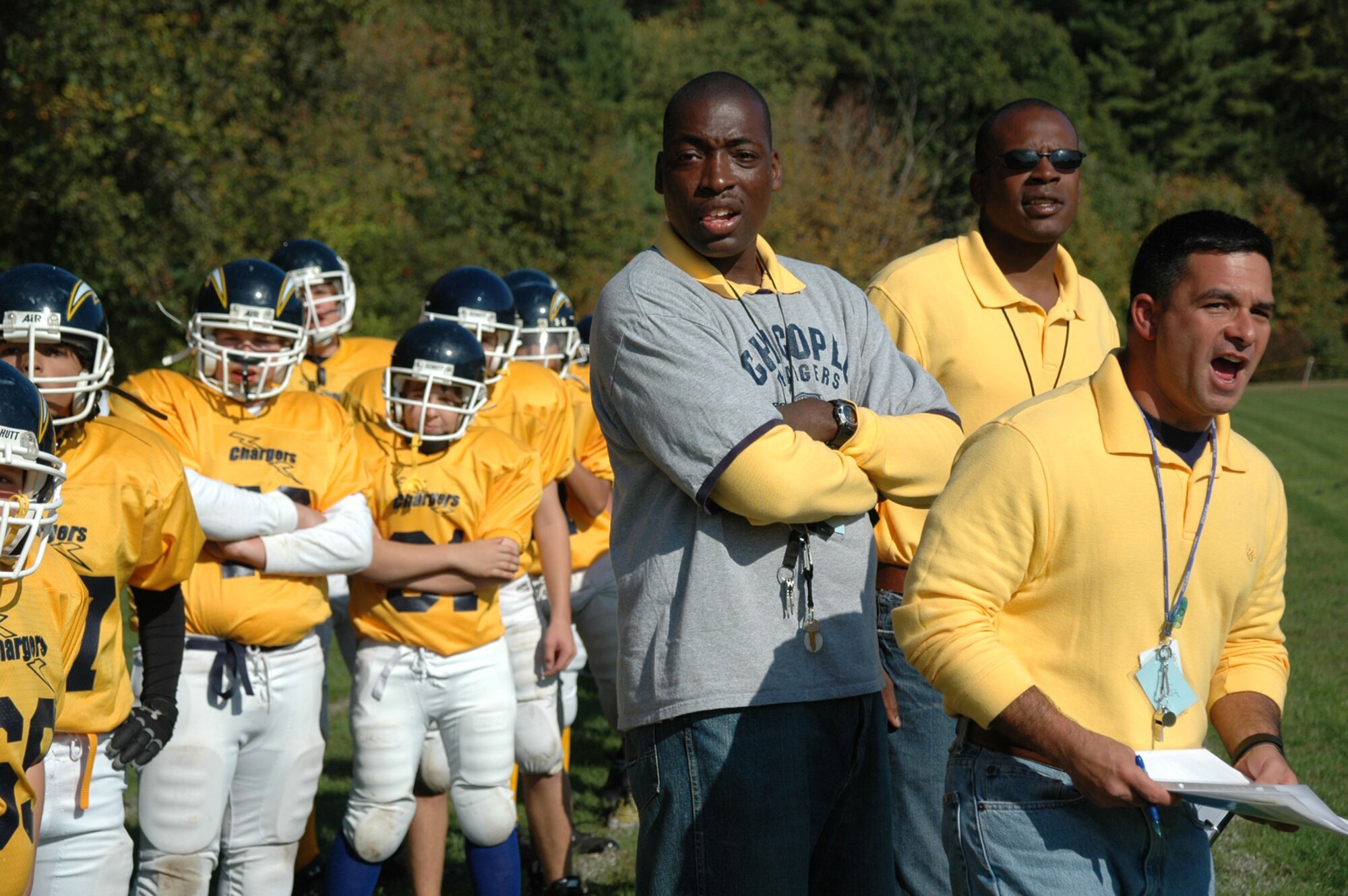 SIDELINE STRATEGIES -- (From left) Coaches Zaki-Jabbar Robinson, Alan Fairey, and Pete Hilario call out plays from the sidelines. (US Air Force photo/Senior Master Sgt. Sandi Michon)