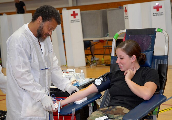 Leonard Hilton checks Airman 1st Class Renee Turcotte's blood pressure prior to drawing her blood during an American Red Cross Blood Drive held at the fitness and sports center Oct. 15. One-hundred twenty-seven Team Charleston members participated in the blood drive to donate a total of 140 pints of red cell blood and whole blood.  Mr. Hilton is a collection specialist with the American Red Cross and Airman Turcotte is a receiving specialist with the 437th Logistics Readiness Squadron. (U.S. Air Force photo/Airman 1st Class Melissa White)