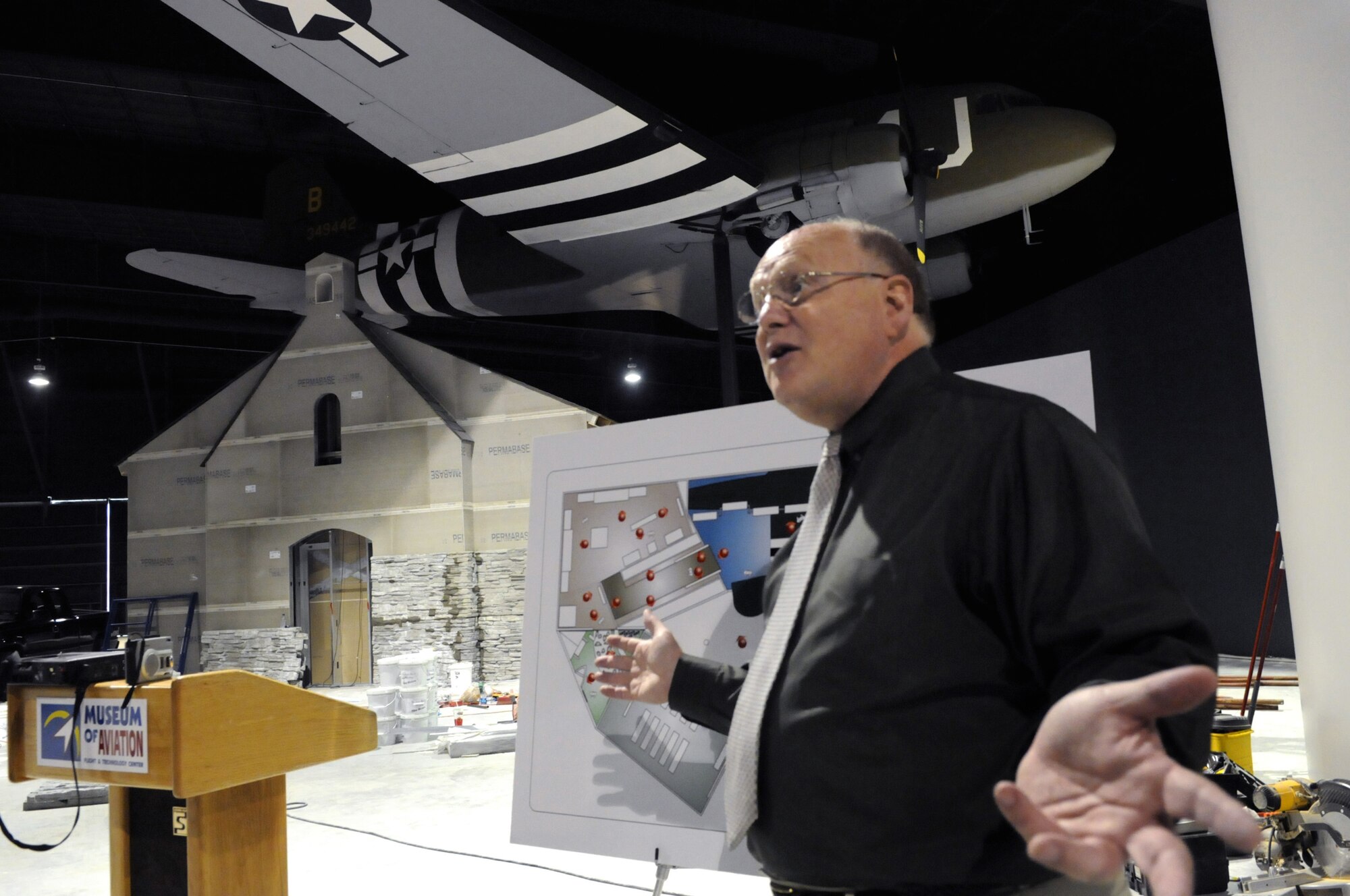 Michael Pierce, Museum of Aviation exhibits designer, talks about the different areas in  Down to Earth, The 507th parachute infantry regiment and the air invasion of Normandy exhibit , Sept. 25. The over 6,000 square-foot exhibit will be the highlight of the new World War II hangar Oct. 17-18. U. S. Air Force photo by Sue Sapp
