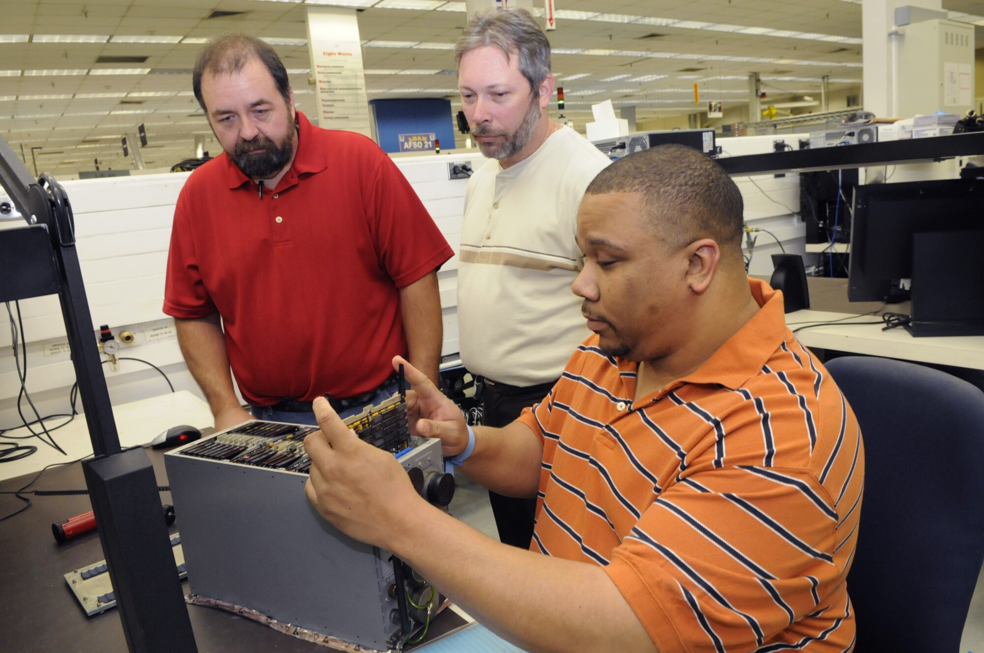 L-R George Crawford, Robert Foster and Leroy Phillips developed a repair process for the PSDP (programable signal data processor). U. S. Air Force photo by Sue Sapp