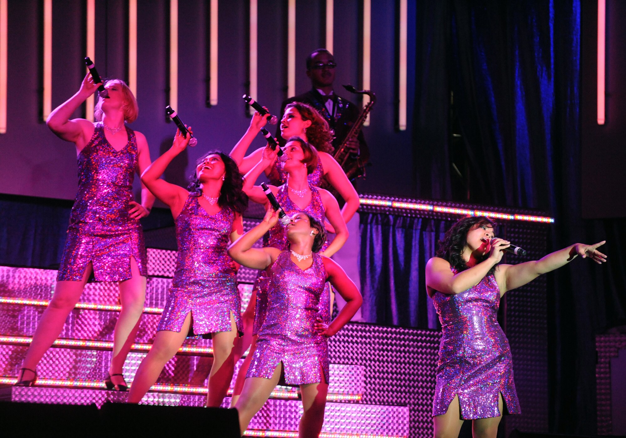 LANGLEY AIR FORCE BASE, Va. -- 2nd Lt. Rhoda Lazo, Tops in Blue vocalist, leads a group of vocalist in the opening performance Oct. 12.  Tops in Blue is a widely traveled all active-duty entertainment group, serving the Air Force family with priority to personnel stationed worldwide at remote and deployed locations.  (U.S. Air Force photo/Senior Airman Vernon Young)