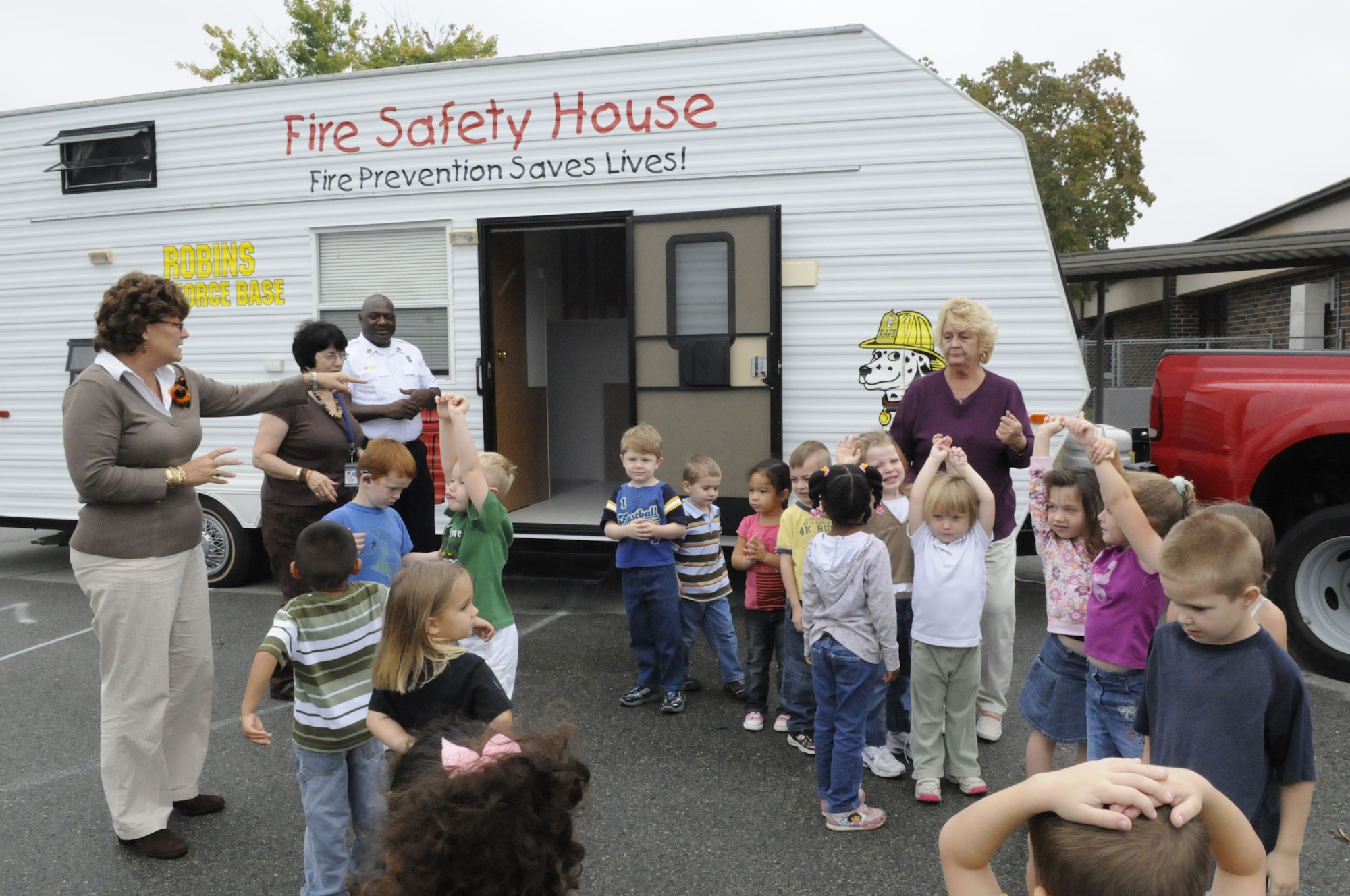 Robins Elementary pre-kindergarten students have their chance to tour the Fire Safety House Oct. 9. Children learn safety tips for the kitchen, living room and bedroom and are taught how to call 911 and make an escape from a house in the event of a fire. U. S. Air Force photo by Sue Sapp