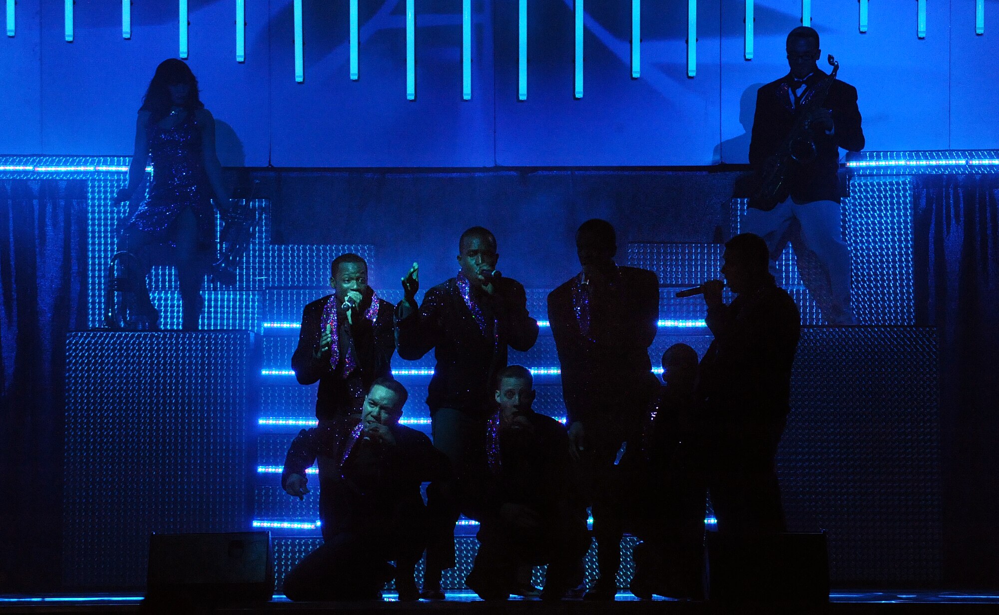 LANGLEY AIR FORCE BASE, Va. -- Male vocalists of the Tops in Blue band sing during a world tour performance Oct. 12.  Tops in Blue is a widely traveled all active-duty entertainment group, serving the Air Force family with priority to personnel stationed worldwide at remote and deployed locations.  (U.S. Air Force photo/Senior Airman Vernon Young)