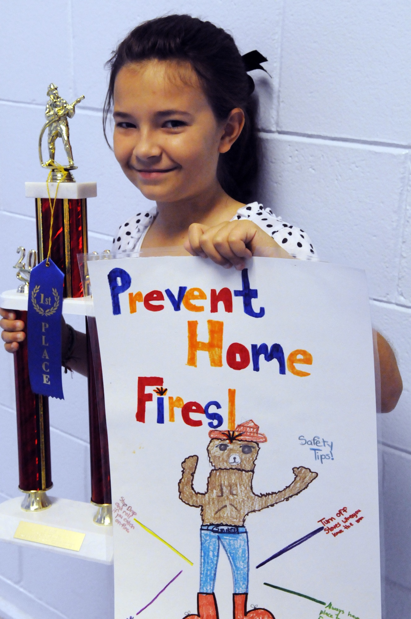 Alyssa Toellner, Robins Elementary 4th grade student, was the overall winner of the Fire Prevention poster contest. She received a trophy and a $25 gift card. U. S. Air Force photo by Sue Sapp