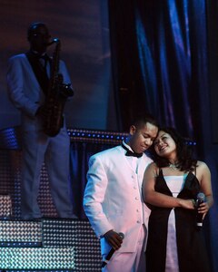 LANGLEY AIR FORCE BASE, Va. -- Staff Sgt. Oliver Dagum and Senior Airman Cristy Lagazo, Tops in Blue vocalists, hug during a world tour performance.  Tops in Blue is a widely traveled all active-duty entertainment group, serving the Air Force family with priority to personnel stationed worldwide at remote and deployed locations.  (U.S. Air Force photo/Senior Airman Vernon Young)
