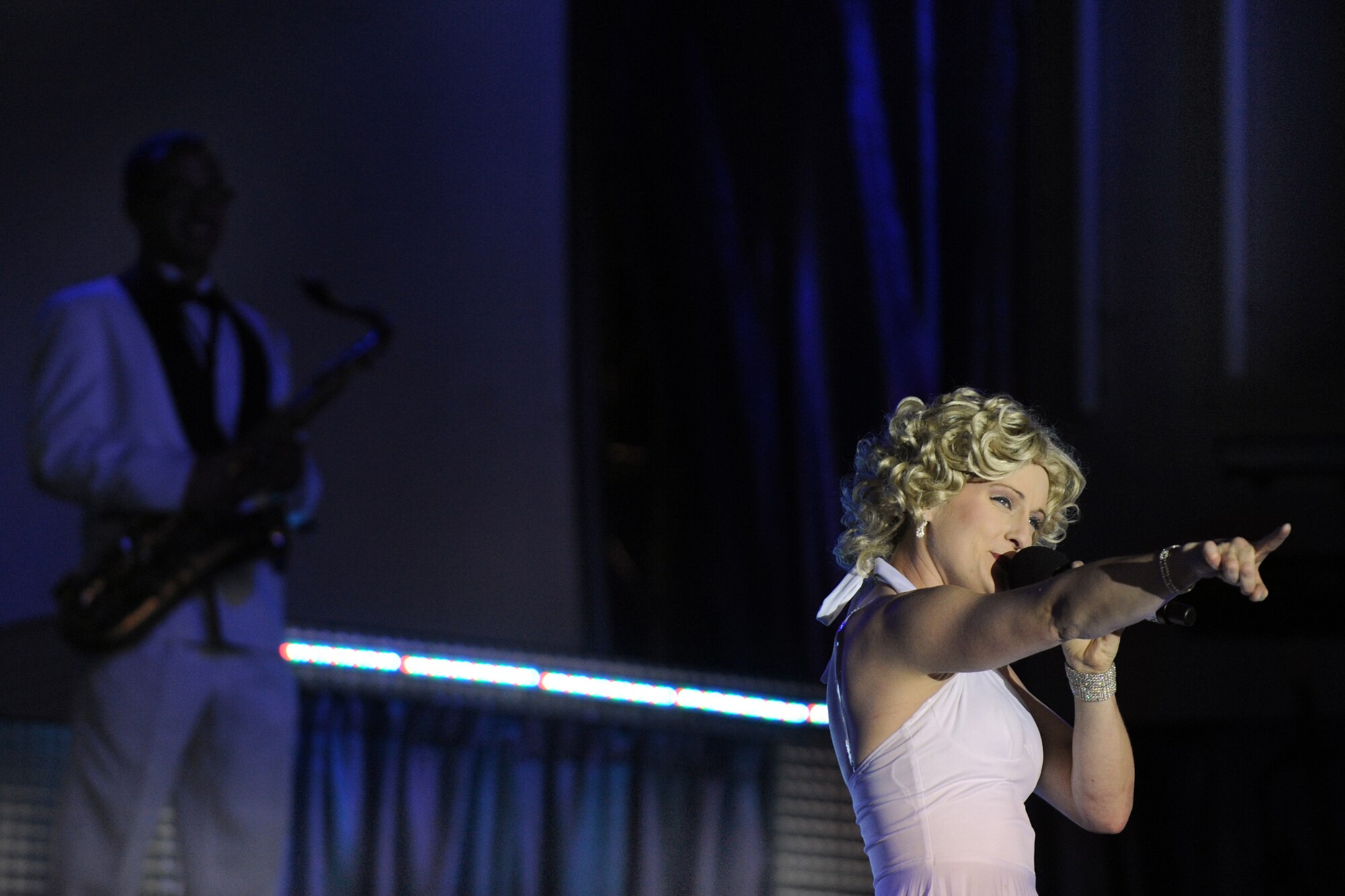 LANGLEY AIR FORCE BASE, Va. -- Tech. Sgt. Bridgett Johnson, Tops in Blue vocalist, sings during a world tour performance Oct. 12.  Tops in Blue is a widely traveled all active-duty entertainment group, serving the Air Force family with priority to personnel stationed worldwide at remote and deployed locations.  (U.S. Air Force photo/Senior Airman Vernon Young)