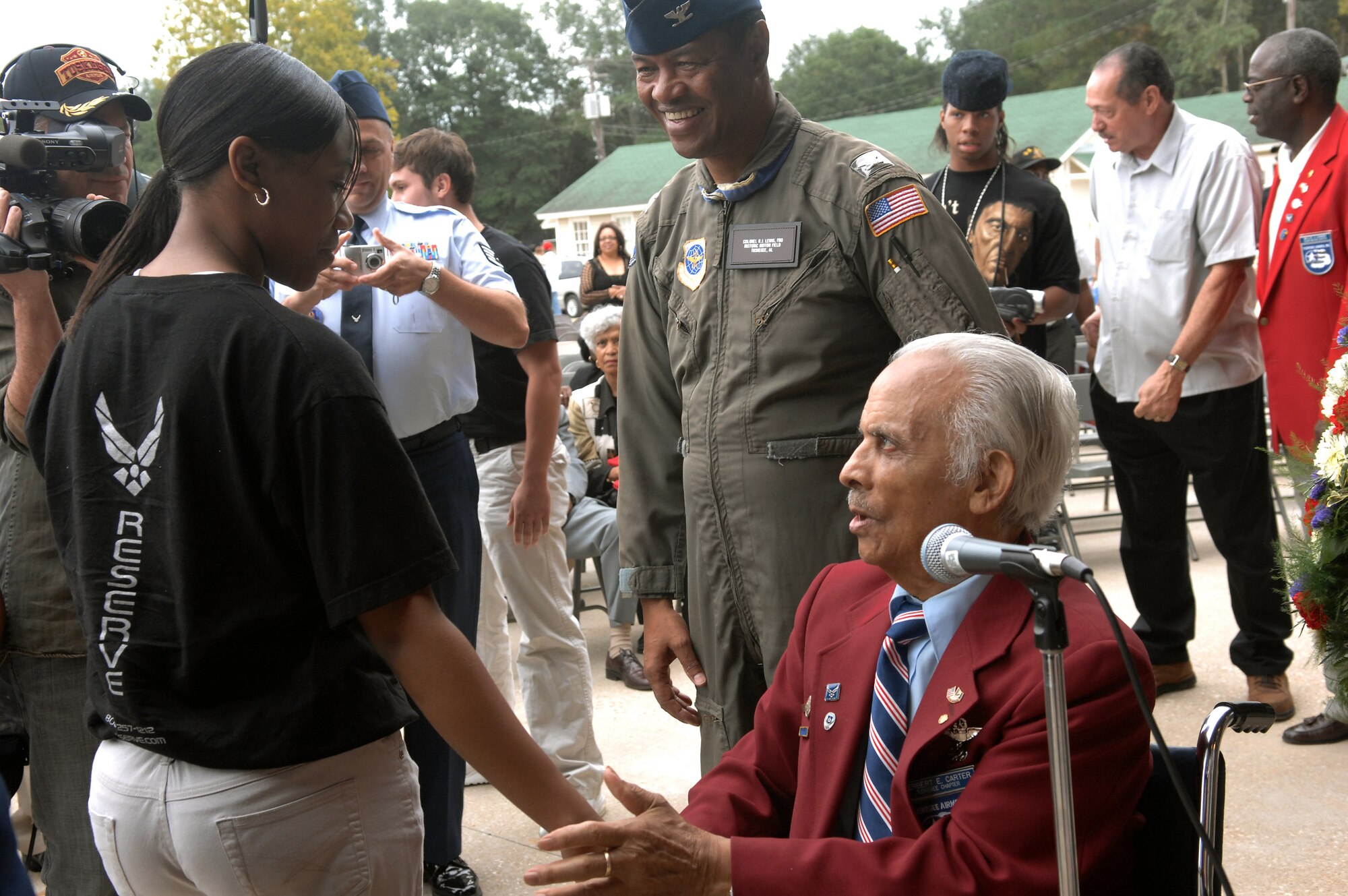 Retired Col. Herbert E. Carter shakes hands with an Airman who he just gave the oath of re-enlistment to Oct. 11 at Moton Field in Tuskegee, Ala. Colonel Carter is one of the original members of the Tuskegee Airmen and was on hand for the opening of the Tuskegee Airmen National Historic Site. Moton Field in the 1940s was the only primary flight training facility for the first African American pilot candidates in the Army Air Corps, these pilots are known as the Tuskegee Airmen. (U.S. Air Force photo/Staff Sgt. Christine Jones)

