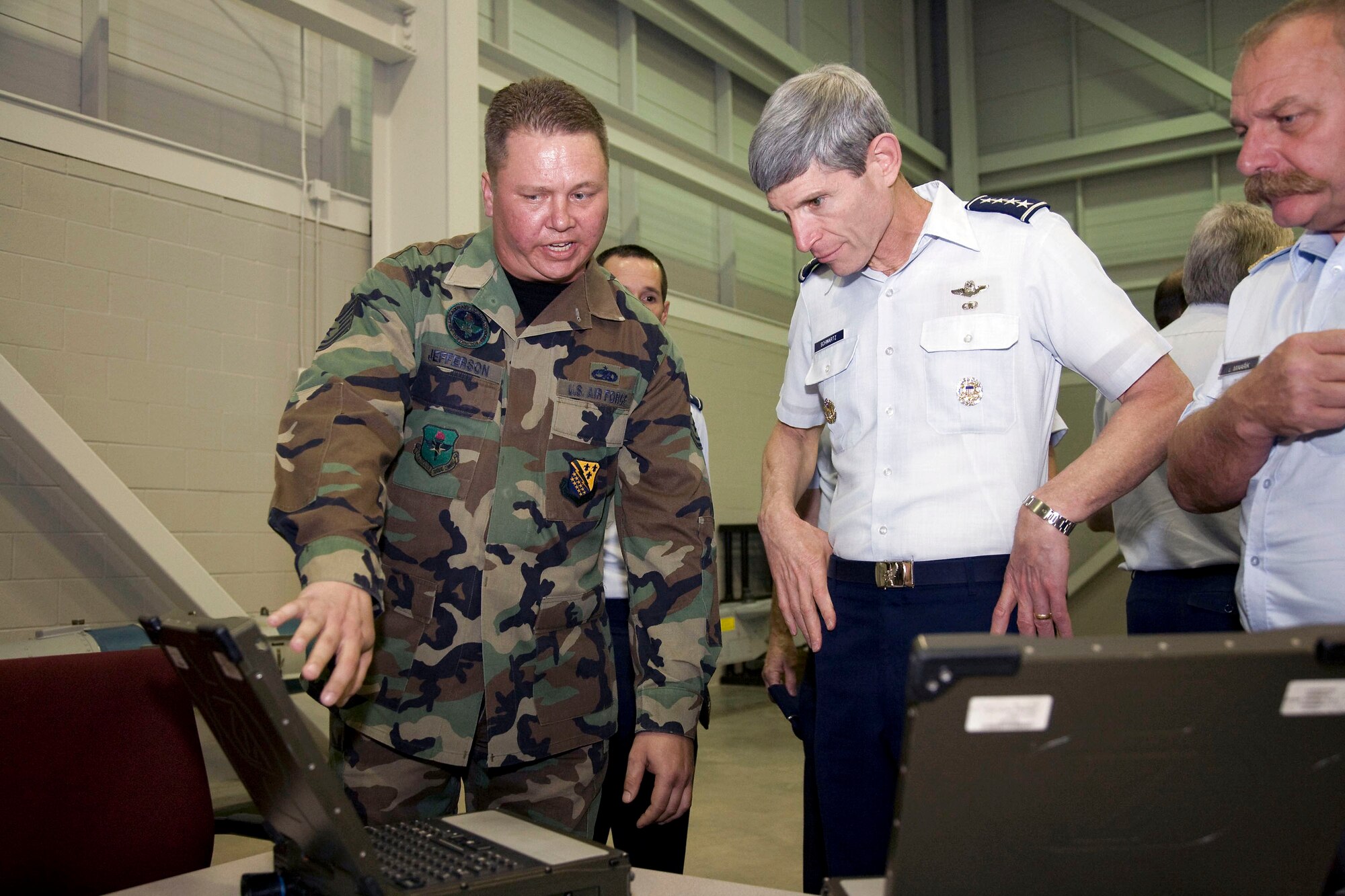 Tech. Sgt. John Jefferson briefs Gen. Norton A. Schwartz on the integrated maintenance information system applications and how the applications are used on the F-22 Raptor Oct. 9. Sergeant Jefferson is a F-22 crew chief instructor supervisor, and General Schwartz is the Air Force chief of staff. (U.S. Air Force photo/Lt. Col. Ternell Washington) 
