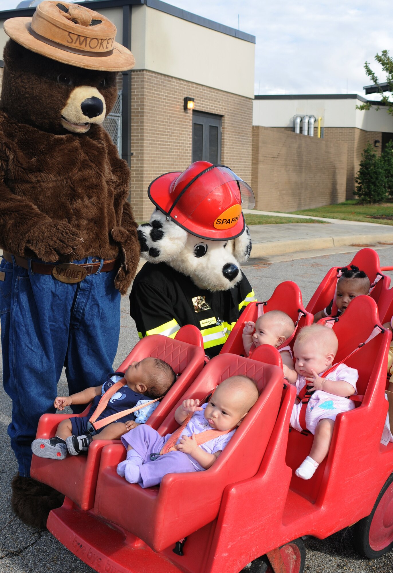 Smokey the Bear and Sparky the Fire Dog greet infants from the child development center during a Fire Prevention Week visit Oct. 6.  From left are Darius Craig, son of Staff Sgts. Javon and Latoya Craig, 81st Medical Group; Cassidy Carlisle, daughter of Staff Sgts. Paul Carlisle, 85th Engineering Installation Squadron, and Jackie Carlisle, 335th Training Squadron; Christy Stevenson, daughter of Staff Sgt. Soledad Stevenson, 81st Surgical Operations Squadron; Abbigail Greiman, daughter of Capt. Robert and Luci Greiman, 81st Medical Operations Squadron; and McKenzie McLaurin, daughter of Krystal Malloy, Army and Air Force Exchange Service.  More photos, Page 14.  (U.S. Air Force photo by Kemberly Groue)