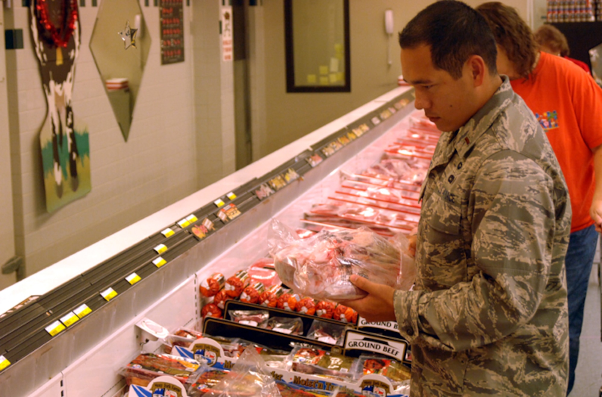 Second Lt. Clay Toerner, 14th Operational Support Squadron, selects a leg of lamb from the meat department at the Columbus AFB Commissary. Commissary meat departments sell high quality meat products at significantly lower prices compared to those of supermarkets. (U.S. Air Force photo by Airman Josh Harbin)