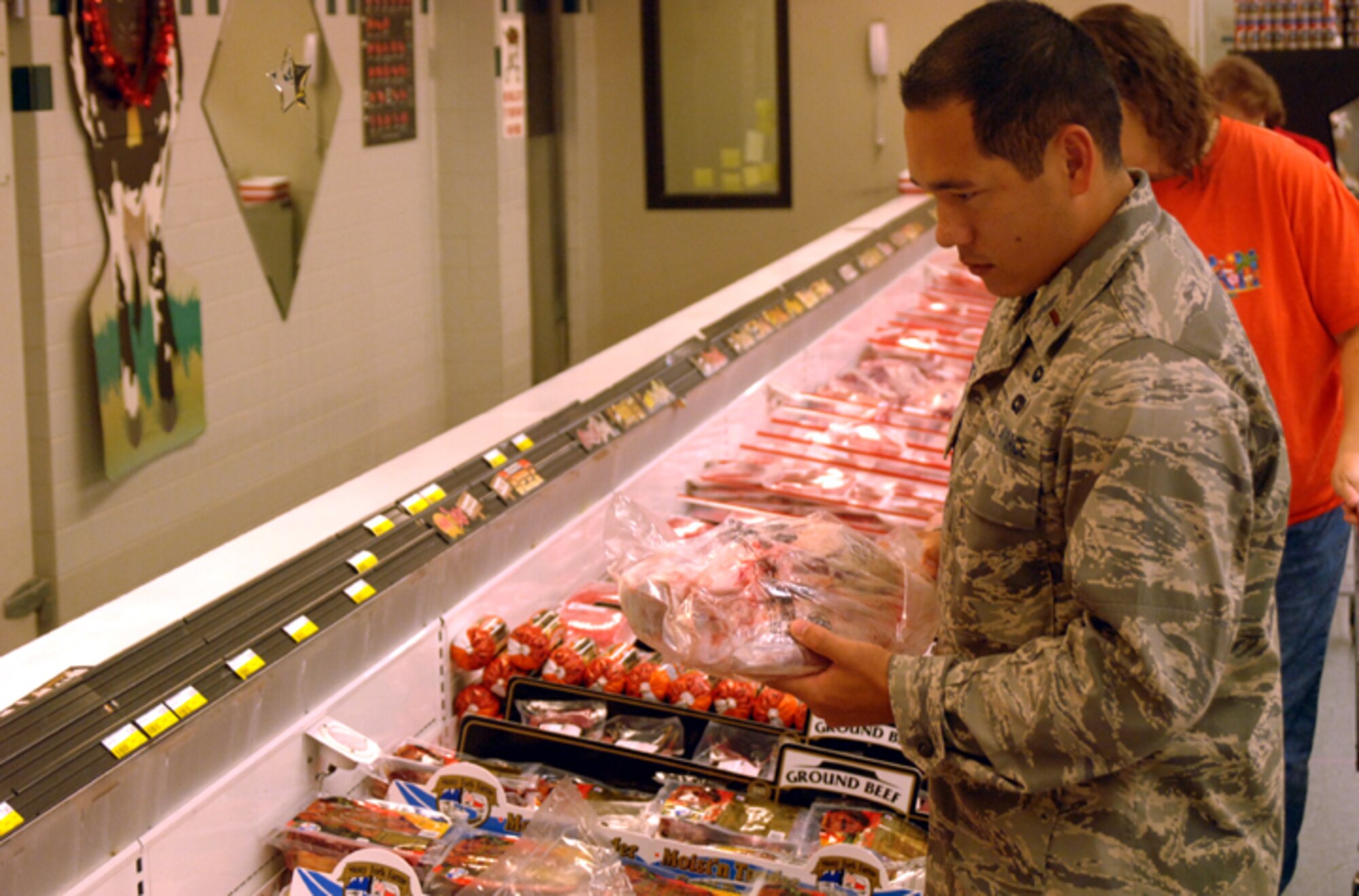 Second Lt. Clay Toerner, 14th Operational Support Squadron, selects a leg of lamb from the meat department at the Columbus AFB Commissary. Commissary meat departments sell high quality meat products at significantly lower prices compared to those of supermarkets. (U.S. Air Force photo by Airman Josh Harbin)