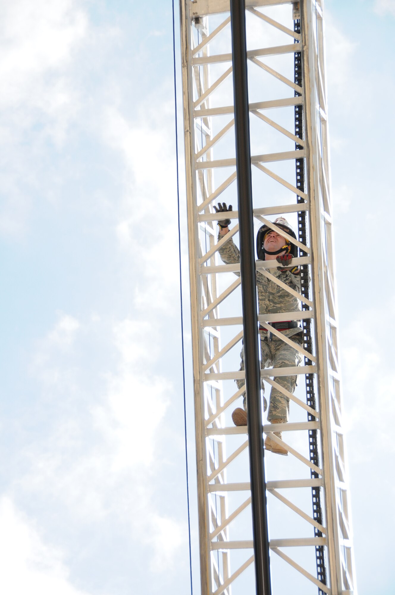 Top, Brig. Gen. Greg Tou-hill, 81st Training Wing commander, scales a fire truck ladder at Saturday’s open house which ended the base’s Fire Prevention Week observance.  (U.S. Air Force photo by Kemberly Groue)

