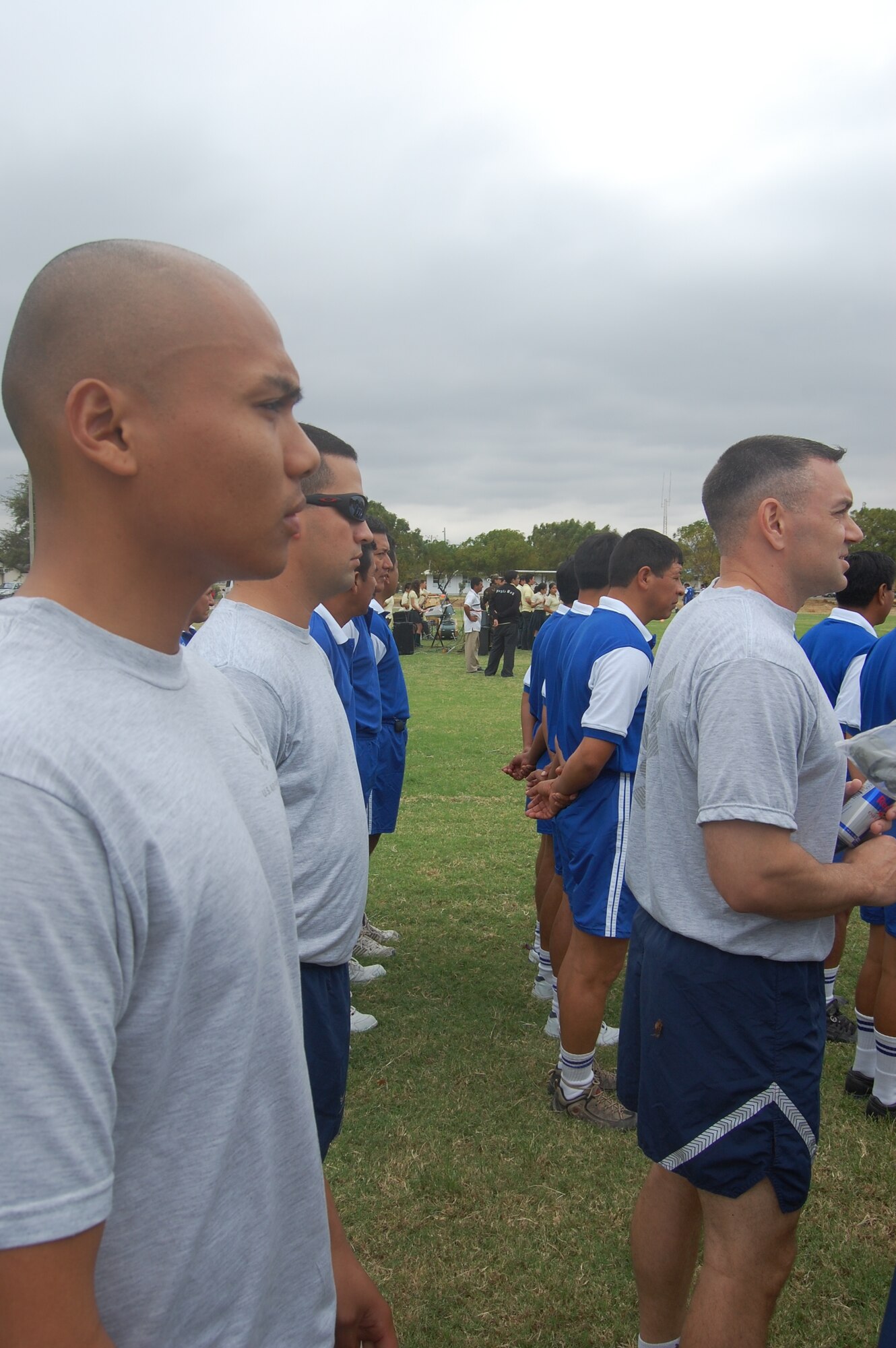 FORWARD OPERATING LOCATION MANTA, Ecuador -- Airmen from the 478th Expeditionary Operations Squadron and members of the Ecuadorian Air Force watch during opening ceremonies for the Ecuadorian Air Force sports competition. The six-week competition features basketball, volleyball, soccer and track events. (US Air Force Photo/1Lt. Lauren Wright)