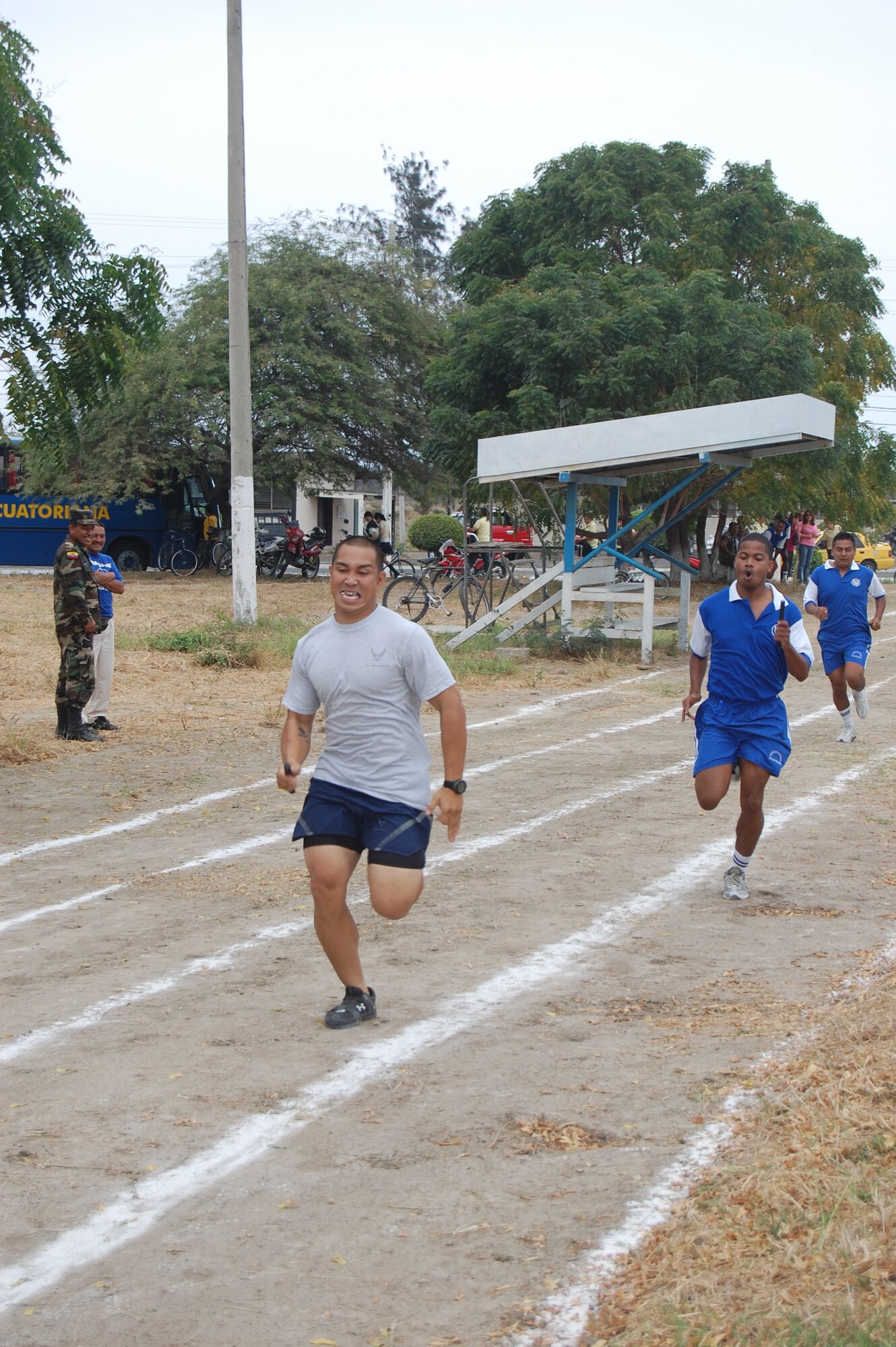 FORWARD OPERATING LOCATION MANTA, Ecuador -- Senior Airman William Bullicer, 478th Expeditionary Operations Squadron security forces member, deployed from Holloman Air Force Base, N.M., competes in a leg of the 4x300-meter relay competition at the Ecuadorian Air Force sports competition. The six-week competition features basketball, volleyball, soccer and track events. (US Air Force Photo/1Lt. Lauren Wright)