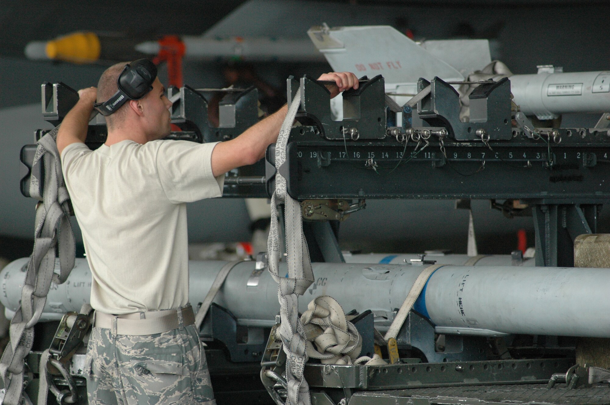 Airman 1st Class Matthew Jones, 60AMU, ensures the MHU-141 Trailer is configured for towing weapons to the aircraft. The trailer must be completely ready for towing prior to the end of the loading operation. (U.S. Air Force Photo/Chrissy Cuttita)