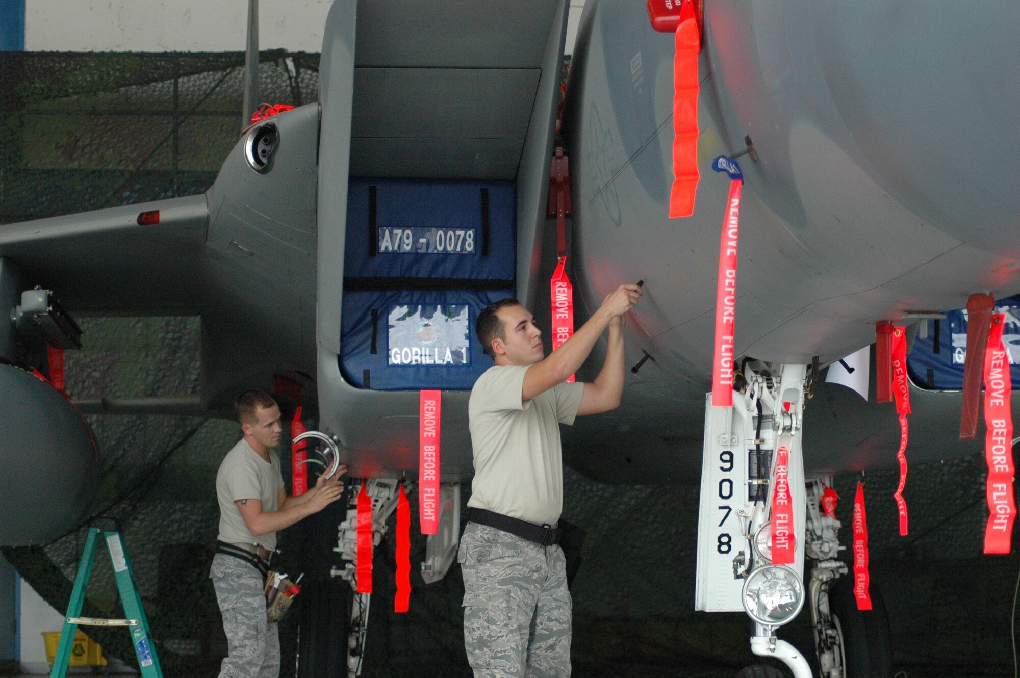 Staff Sgt. David Rodriguez and Airman 1st Class Brian Vetter, 58th Aircraft Maintenance Unit weapons loaders prepares an F-15 for weapons load during the quarterly competition Oct. 10 against the 60th AMU at the 33rd Fighter Wing. (U.S. Air Force Photo/Chrissy Cuttita)
