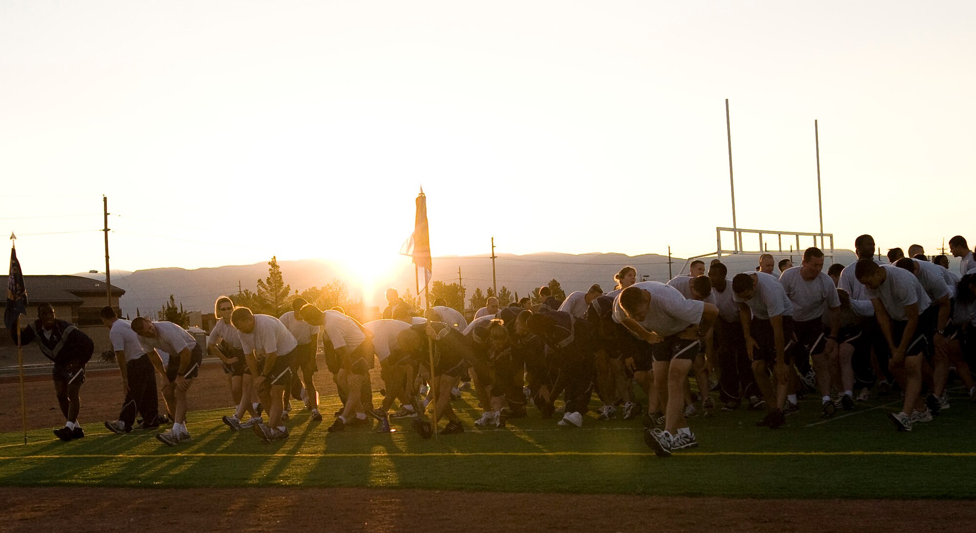 Members of the 49th Fighter Wing stretch on the football field prior to running the wing run at Holloman Air Force Base, N.M., October 10, The wing run kicked of the 2008 Holloman Sports Day.(U.S Air Force photo/Tech Sgt. Alan Port)