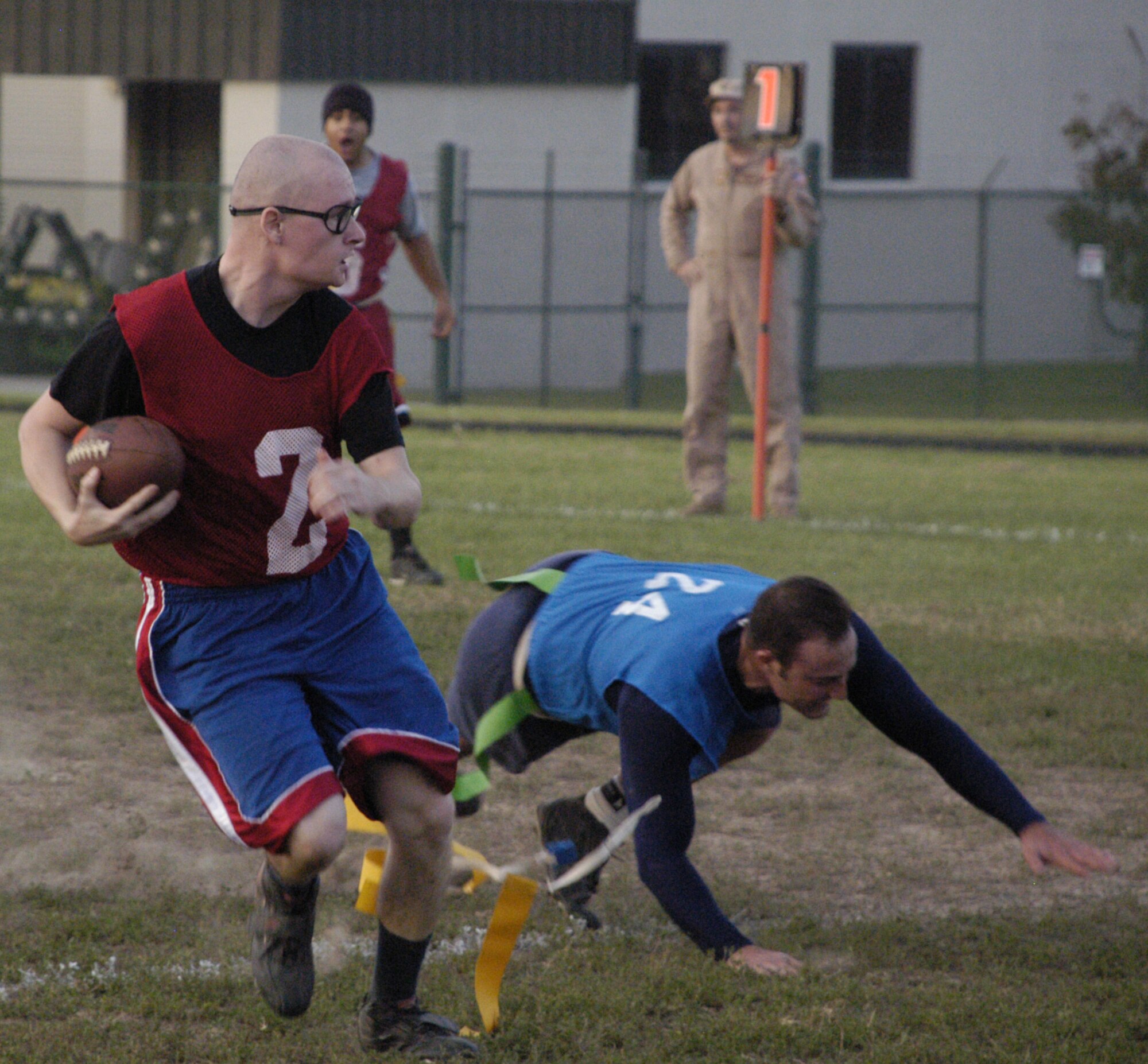 Jerry Baker, OSS tight end, is tackled by Timothy Kniefel, 3 AS safety, during the second half of the game.                                