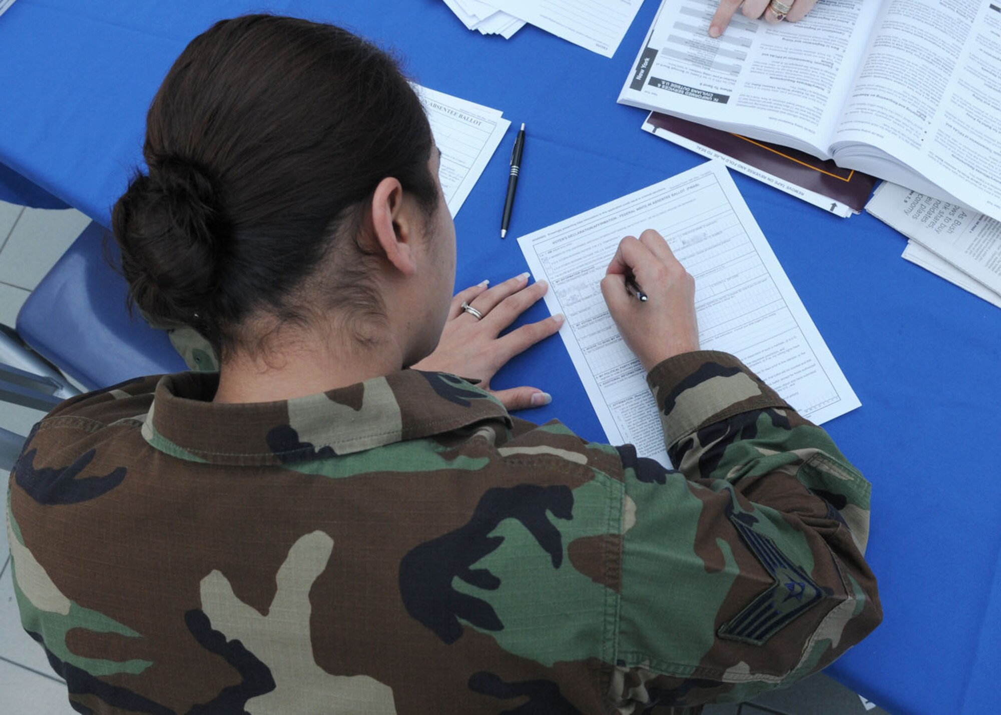 RAF MILDENHALL, England -- Staff Sgt. Barbara Johnson, a personnel craftsman from the 100th Force Support Squadron, fills out an overseas absentee voting form at the BXtra Oct. 15, 2008. This week is the deadline for overseas absentee voting ballots to be submitted. (U.S. Air Force photo by Staff Sgt. Jerry Fleshman)