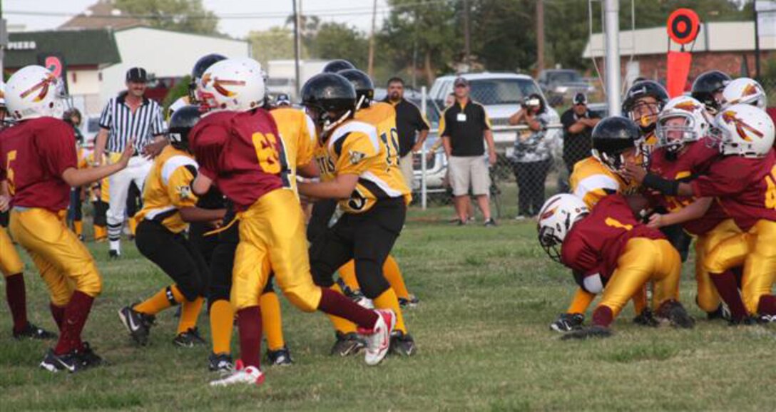 A tackle lead by Redskins Zach Ragsdale, Michael Kiger and Kade Baham stops the team from getting a first down at the Top of Texas North Conference Pee-Wee championship Oct. 11. The Wichita Falls North Redskins, comprised of military family members aged 8-10 years-old, defeated the Bowie North Pirates 14-6. (U.S. Air Force photo)