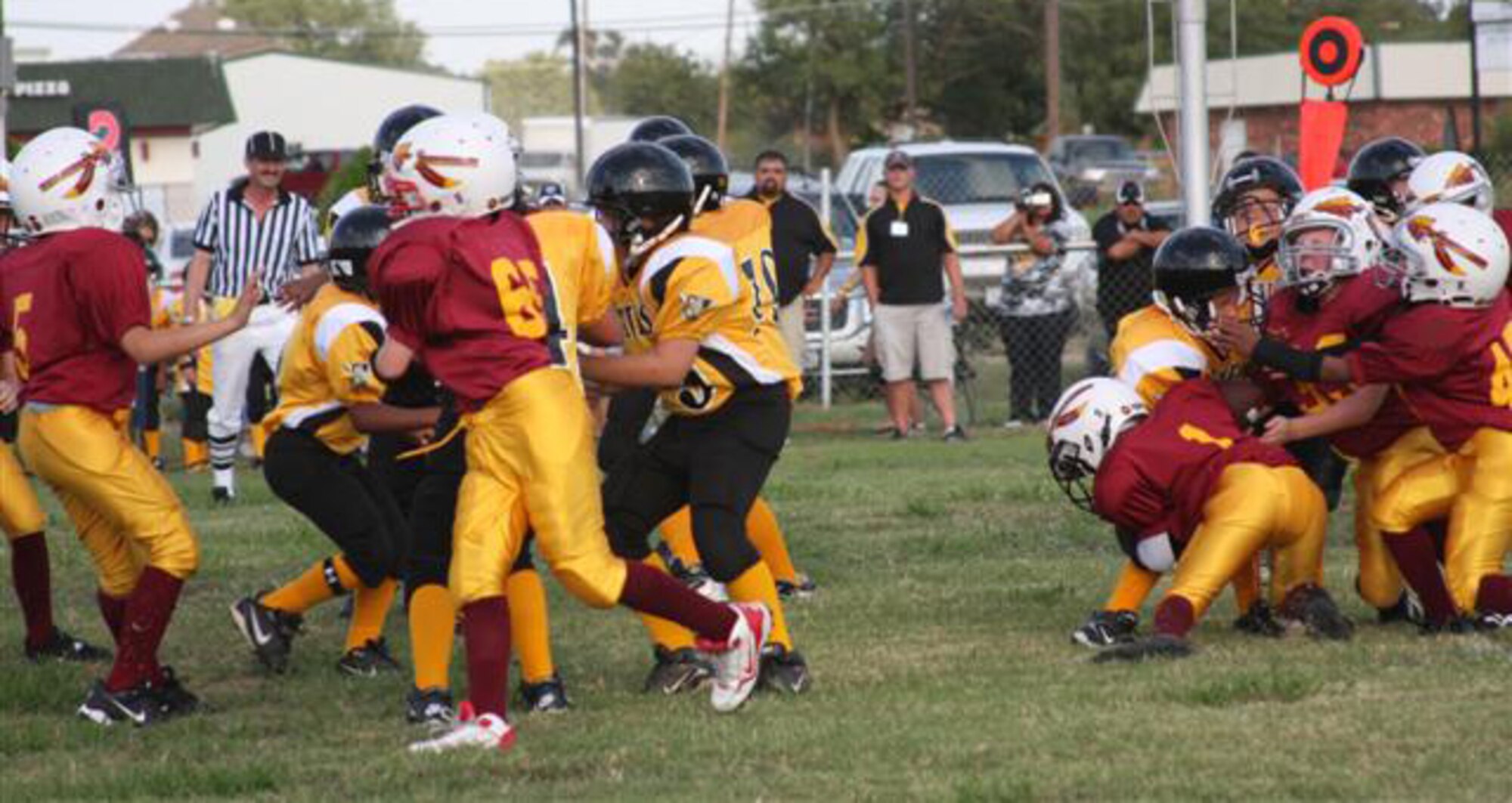 A tackle lead by Redskins Zach Ragsdale, Michael Kiger and Kade Baham stops the team from getting a first down at the Top of Texas North Conference Pee-Wee championship Oct. 11. The Wichita Falls North Redskins, comprised of military family members aged 8-10 years-old, defeated the Bowie North Pirates 14-6. (U.S. Air Force photo)